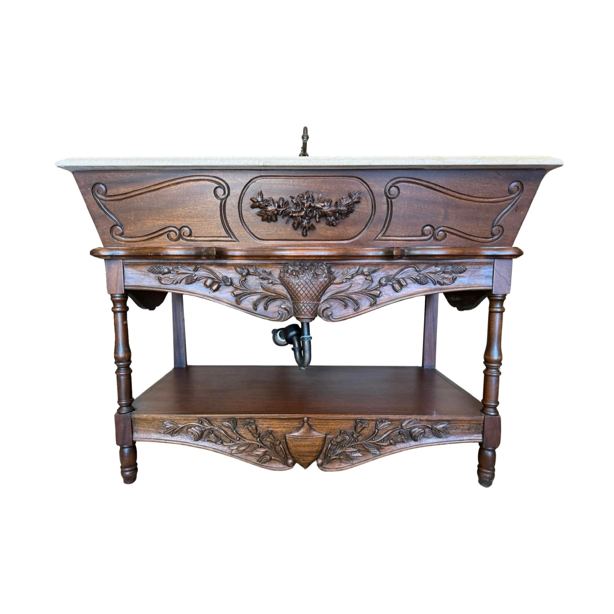 This unique 1880s French Walnut Wood and Travertine Stone Sink is a one-of-a-kind item with a stunning floral carving motif on its walnut wood base, with a travertine stone top sink base. Plus, it comes with French-made copper hardware, a matching