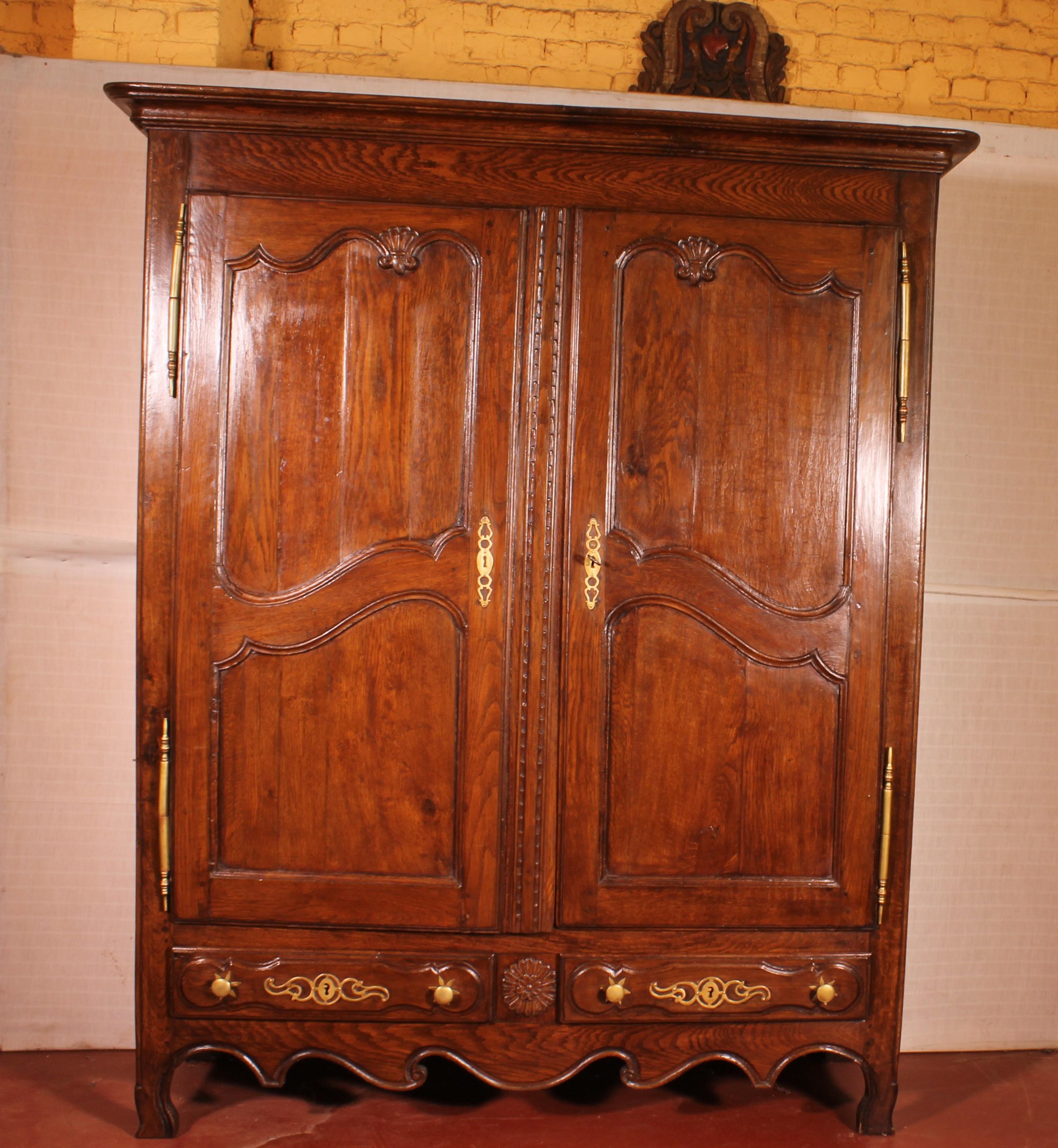 Very beautiful French 18th century armoire from the region Lorraine. 
Extraordinary piece in oak with beautiful flower carving 
We can notice that the wardrobe still has here original irons and keys and here original corniche 

This beautiful