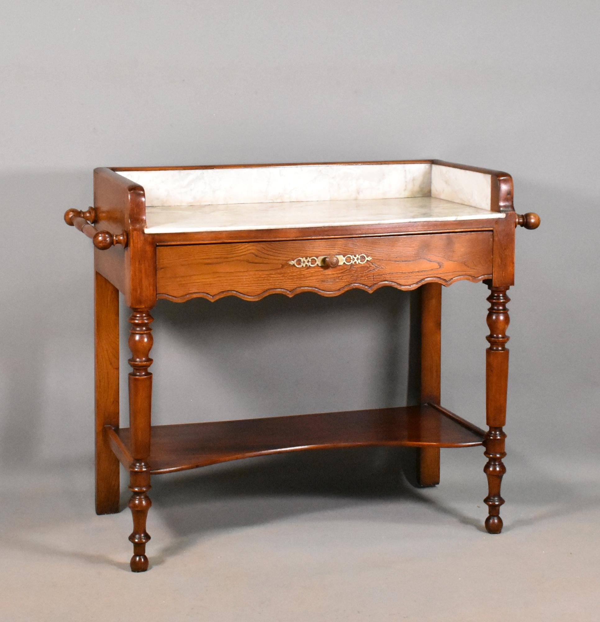 Washstand in Chestnut Louis Philippe Style 

Sourced in South West France, this washstand features a beautiful grey and white variegated marble top and surrounds. 

The solid chestnut frame has a turned towel rail to each side. 

Under the marble is