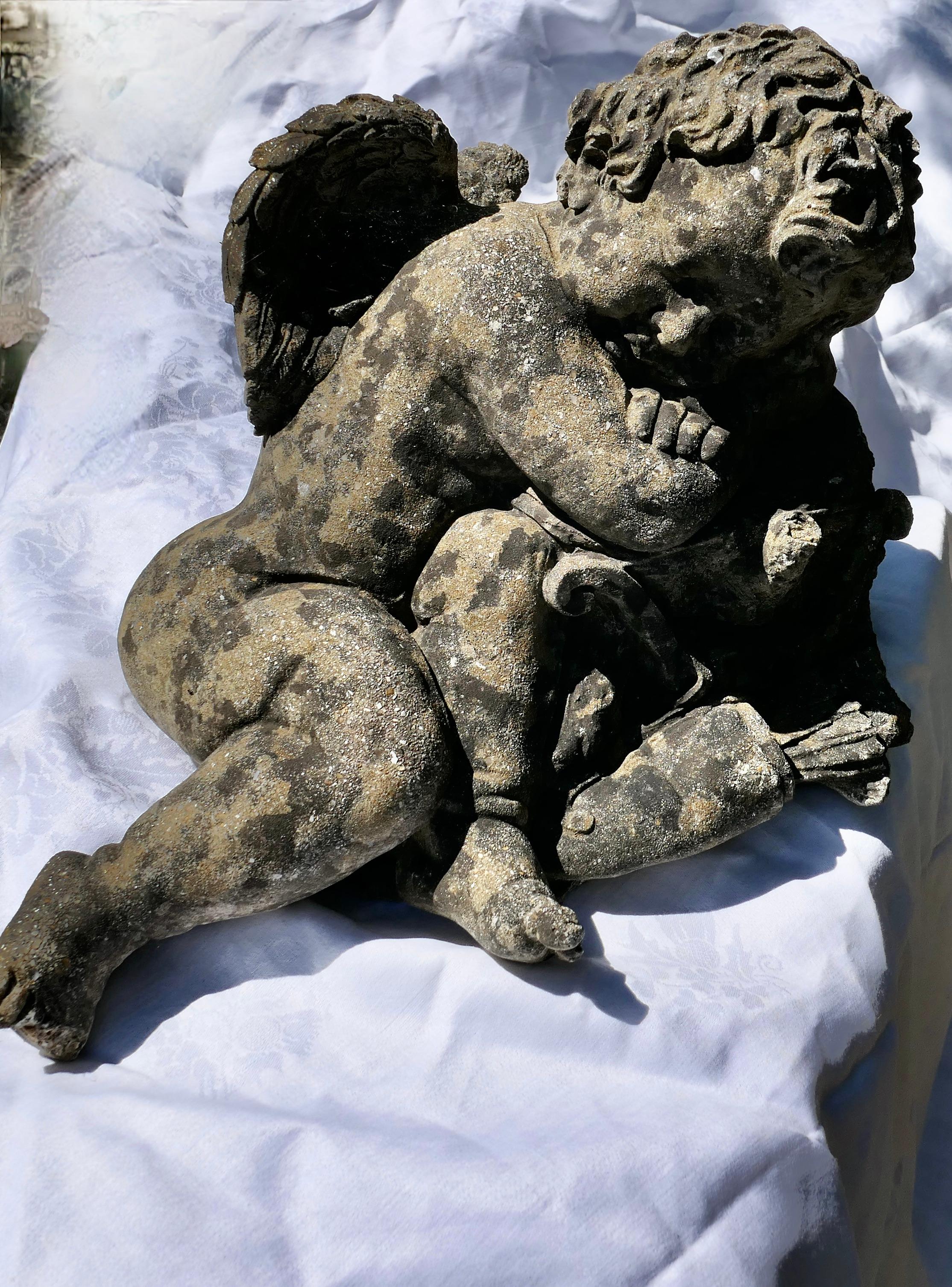 French weathered stone statue of a sleeping putti, baby cherub with wings

Sleeping in the sunshine with his head on his arms and dainty wings on his back
This charming little piece is old and in very weathered condition, he is in 3D detail and
