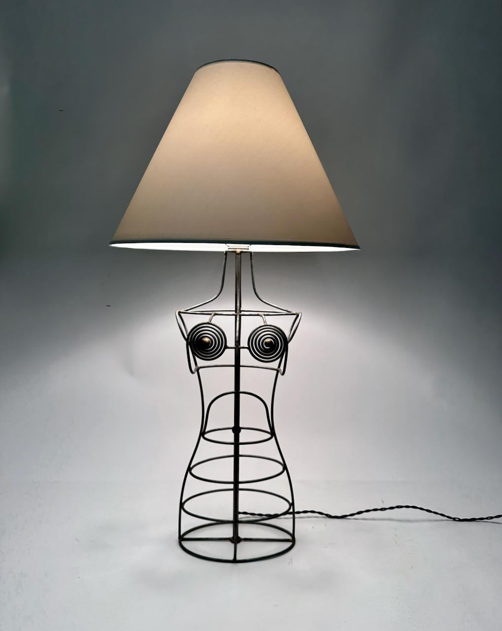 Tall Industrial Modern handcrafted welded galvanized steel wire form mannequin table lamp. Featuring an open abstract sculptural female formed framework. Small footprint. White hardback lamp shade shown for display only and not for sale (11H x 5D