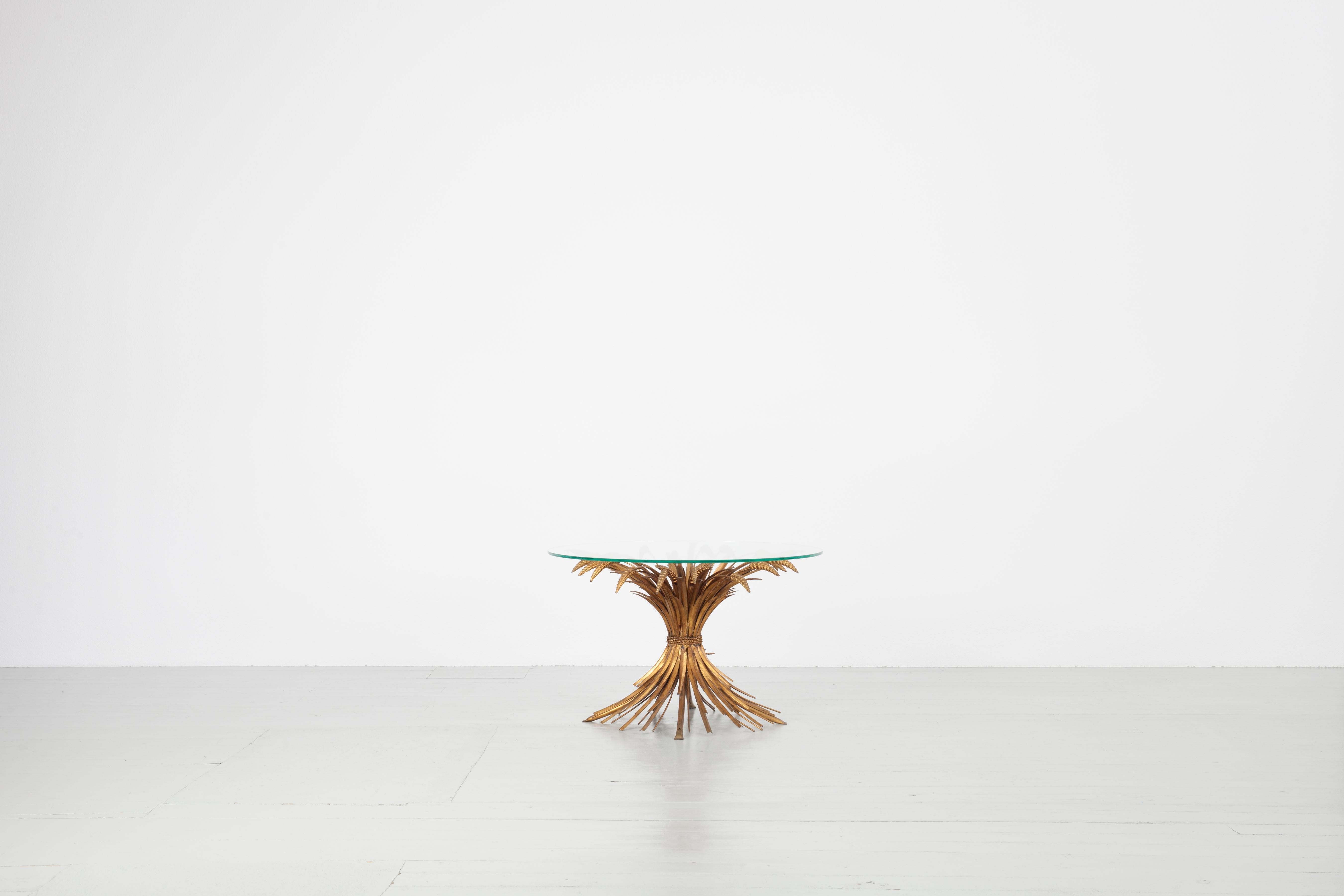 Wheat Sheaf table, France, 1960s. This unique design is closely associated with Coco Chanel and her apartment in the Rue Cambon, Paris. Salvador Dali is said to have given Coco Chanel the table as a gift. The base and frame are made of a gilded