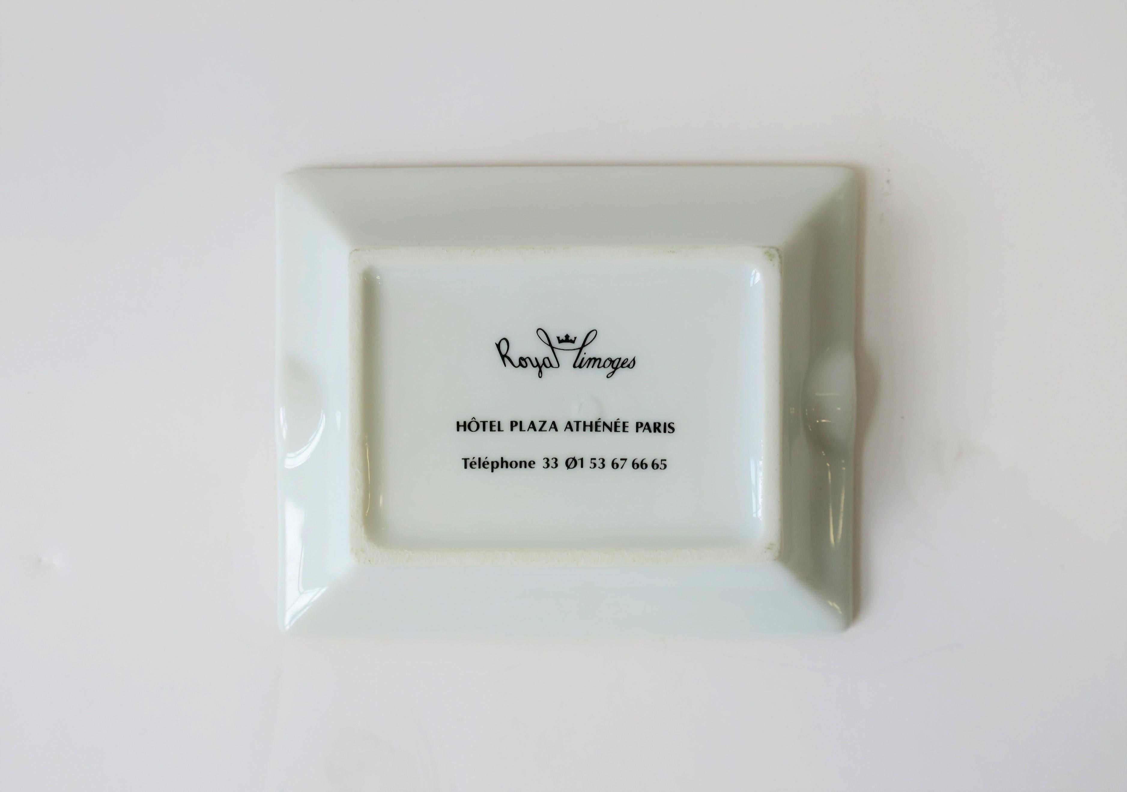 A small rectangular French Limoges white and gold porcelain dish or ashtray from the Hotel Plaza Athenee, Paris, France. With maker's mark on back as shown in image #2. Made by Limoges, France. This small dish serves as a nice piece to hold jewelry,