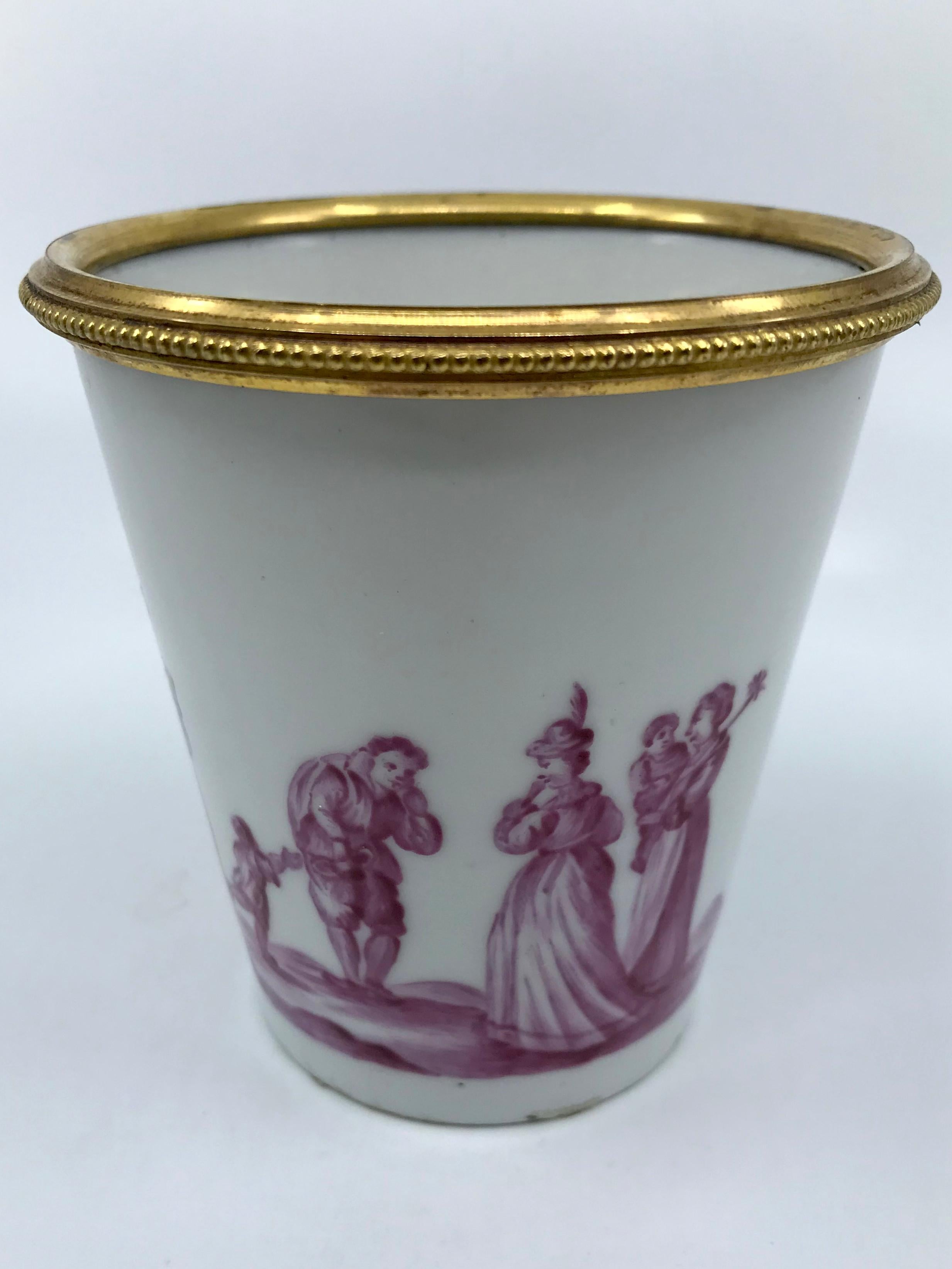 French white and magenta porcelain bud vase. White porcelain vase/pen cup with ormolu beaded rim formerly used as a quill cup with continuous band puce figures in a landscape with markings for Samson. France mid-19th century
Dimensions: 3.88”