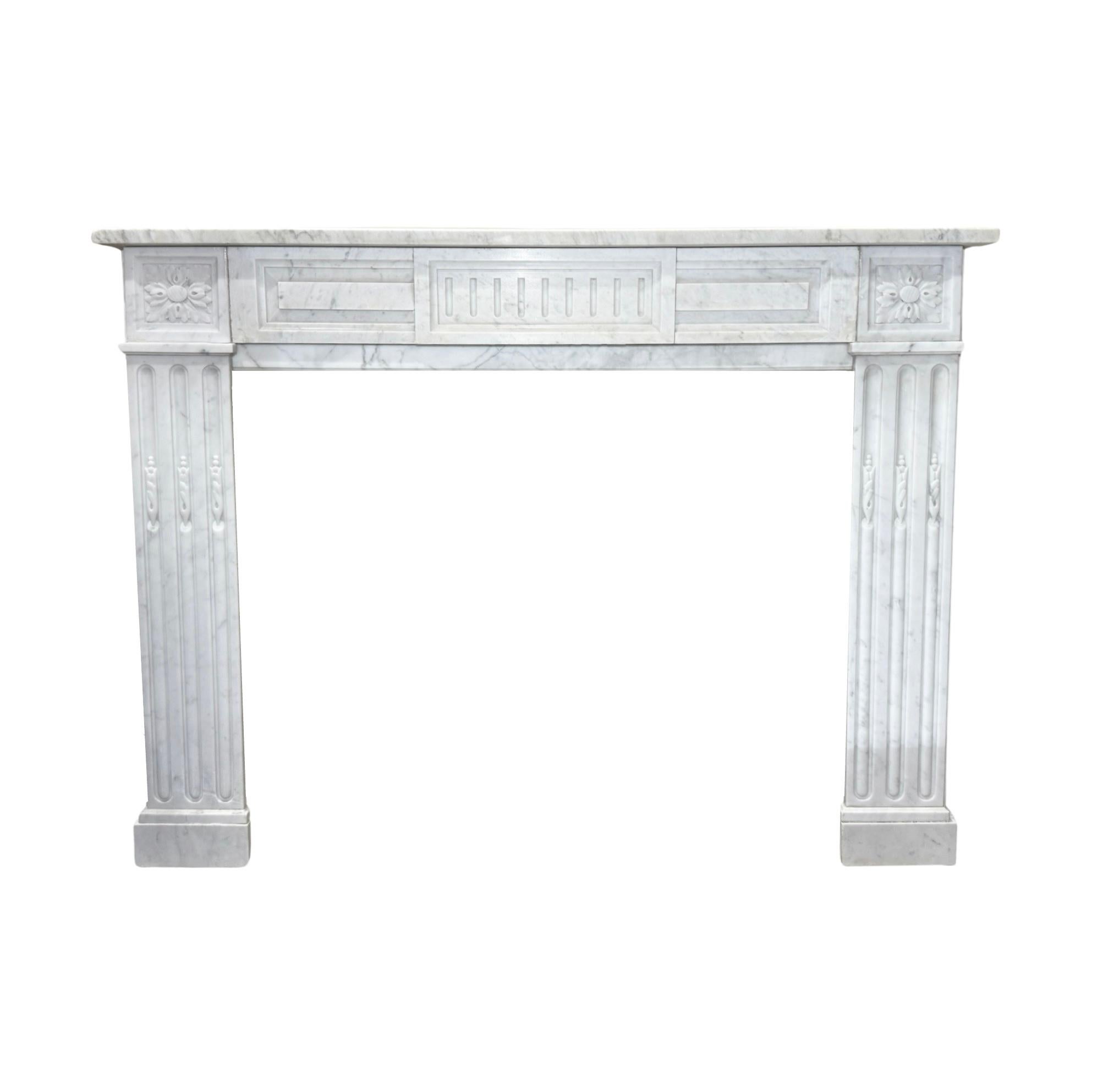 This 19th-century French White Carrara Marble Mantel exudes elegance and sophistication. Crafted from premium quality, white veined marble from France, it features exquisite styled carvings in the iconic Louis XVI style.