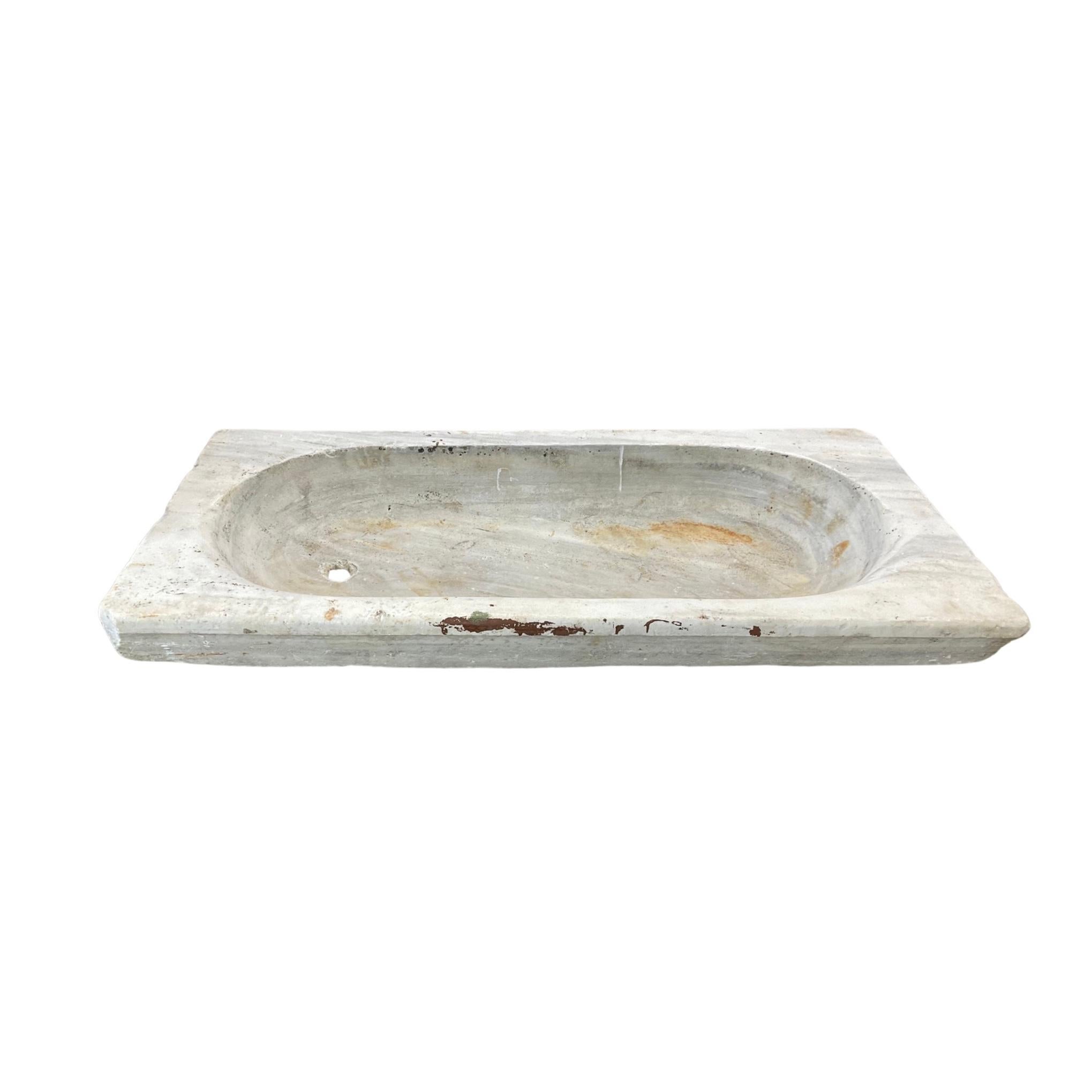 This large classic French White Carrara Marble Sink is finely crafted using luxurious 18th-century marble. Its spacious design and pre-drilled hole allow for easy and efficient drainage. Compliment your space with a cool and pure white look.