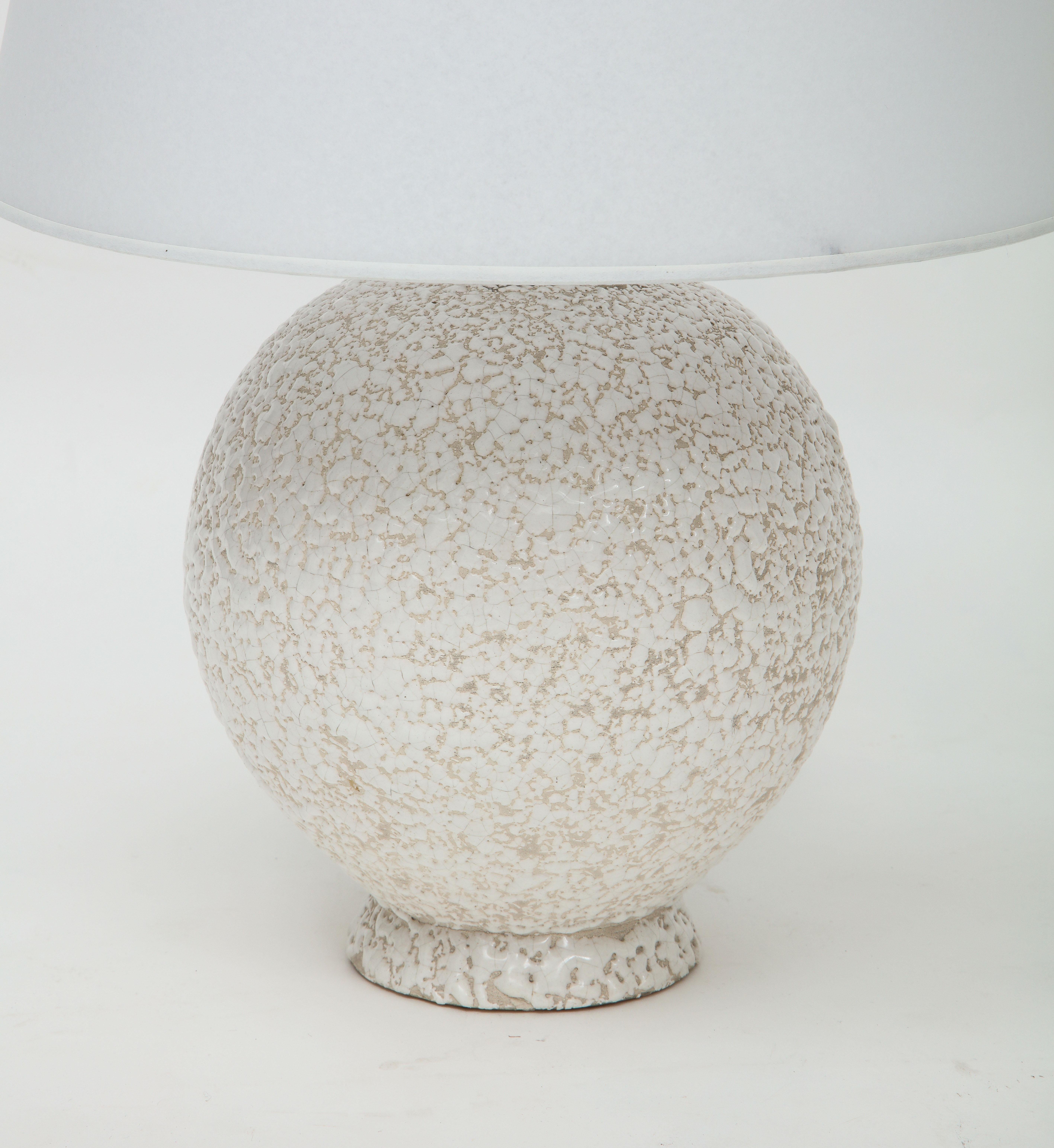 French mid century white ceramic lamp with textured glaze, France, 1940-50's with custom parchment shade
Ceramic, bronze, parchment
Measures: Height 18.75 diameter 8 in. Shade: 13