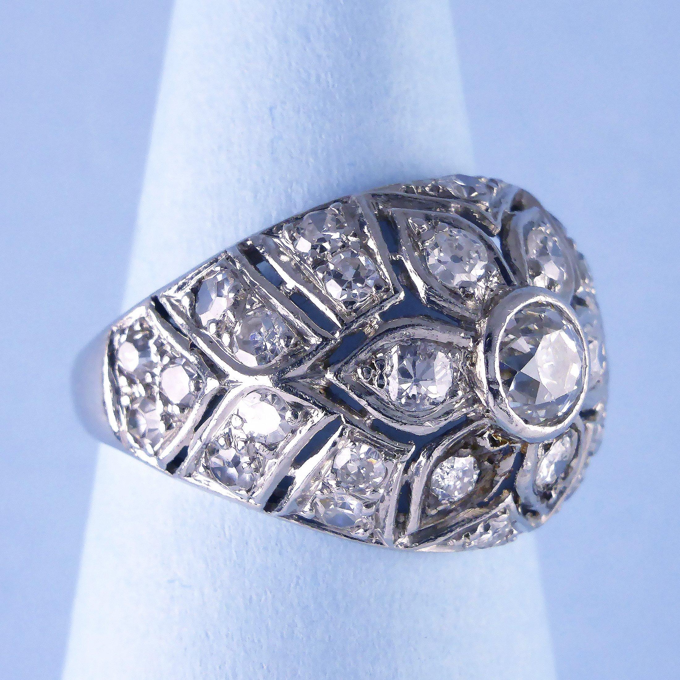 A period bombe ring made circa 1950.

The 18ct white gold ring set with diamonds in a pierced mosaic central flower motif (Diamonds approx 1.40cts).

Measurements at longest/widest point

Dimensions
Width 20mm
Height 15mm

Ring Size:

M (UK)
6 1/4