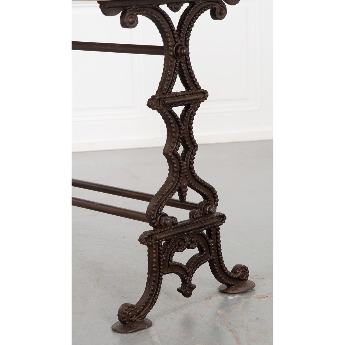 This is a French bistro table. The white marble top is antique and does have a crack in it. Please see detailed images. The iron base is more recent. Although this lovely piece is intended for the patio or garden, it is by no means confined to the