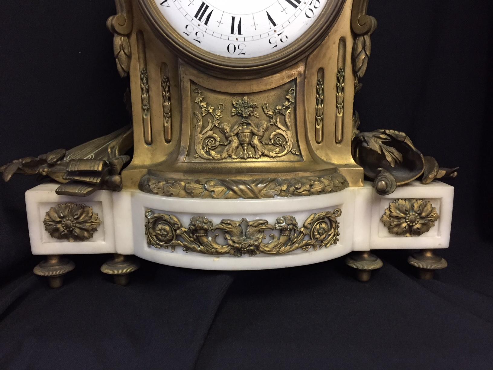 Remarkable 19th century French Louis XVI style ormolu mounted white marble clock with love birds.
Retailed by Tiffany. 

The clock is surmounted with two kissing love birds among foliage and floral garlands intertwined with a flaming torch, over
