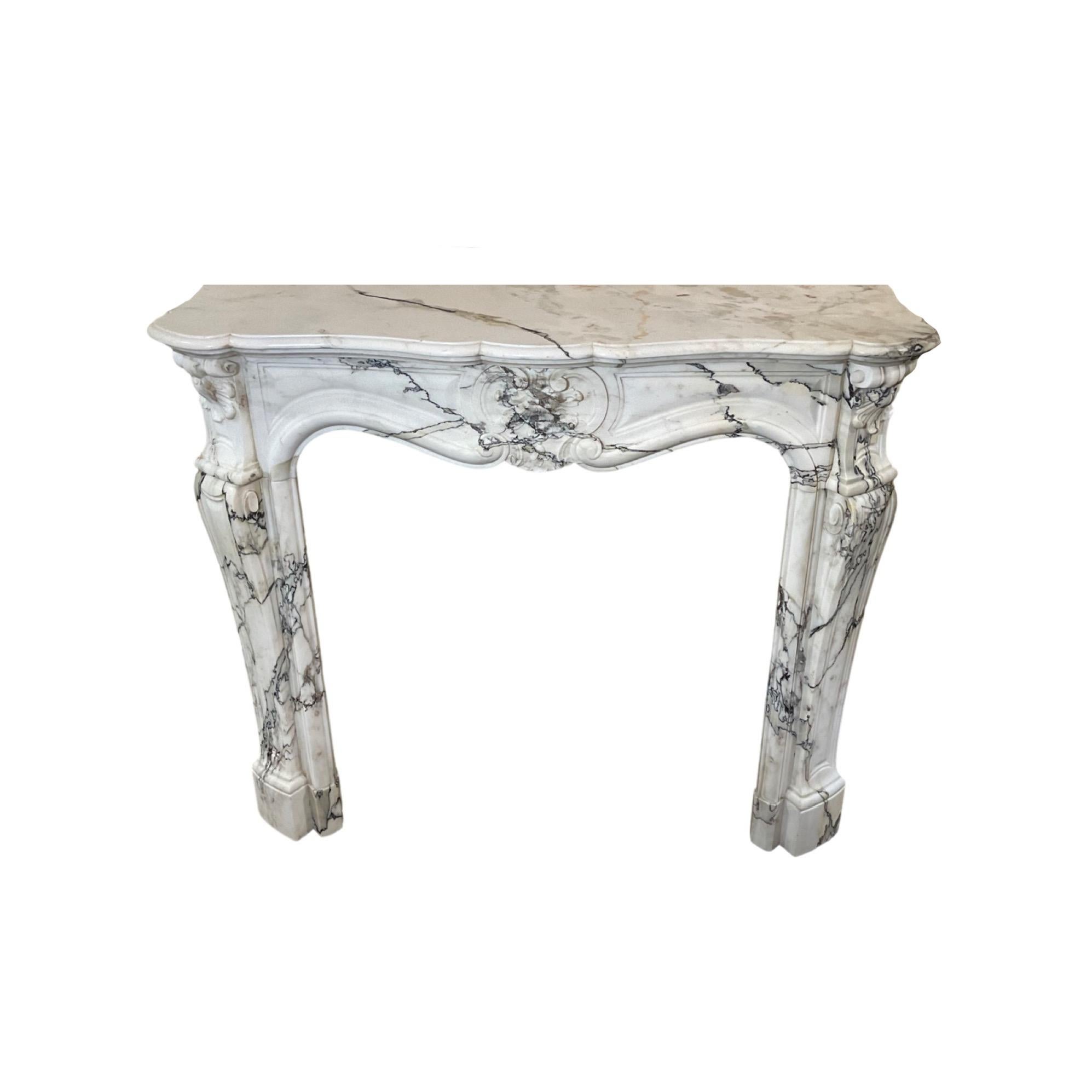 This impressive one-of-a-kind French White Marble Mantel from 1870 features an exquisite Louis XVI design. Crafted in France, this mantel is sure to be a timeless addition to any home.