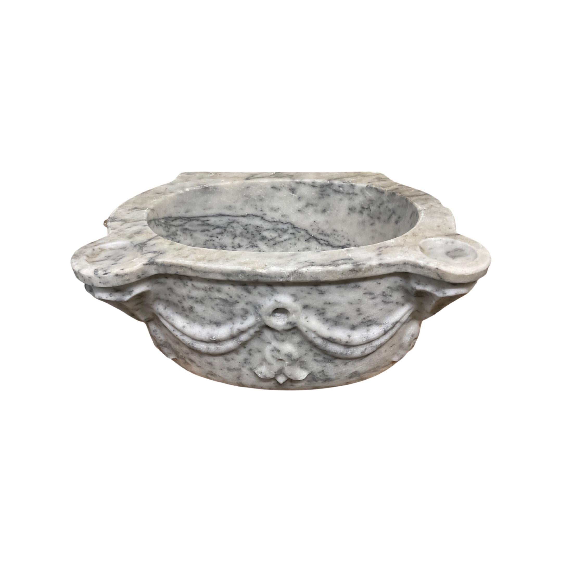 This exquisite French white marble sink is hand carved from the finest White Marble originating from France in the 18th century. Its timeless beauty and durability make it a centerpiece for any bathroom.