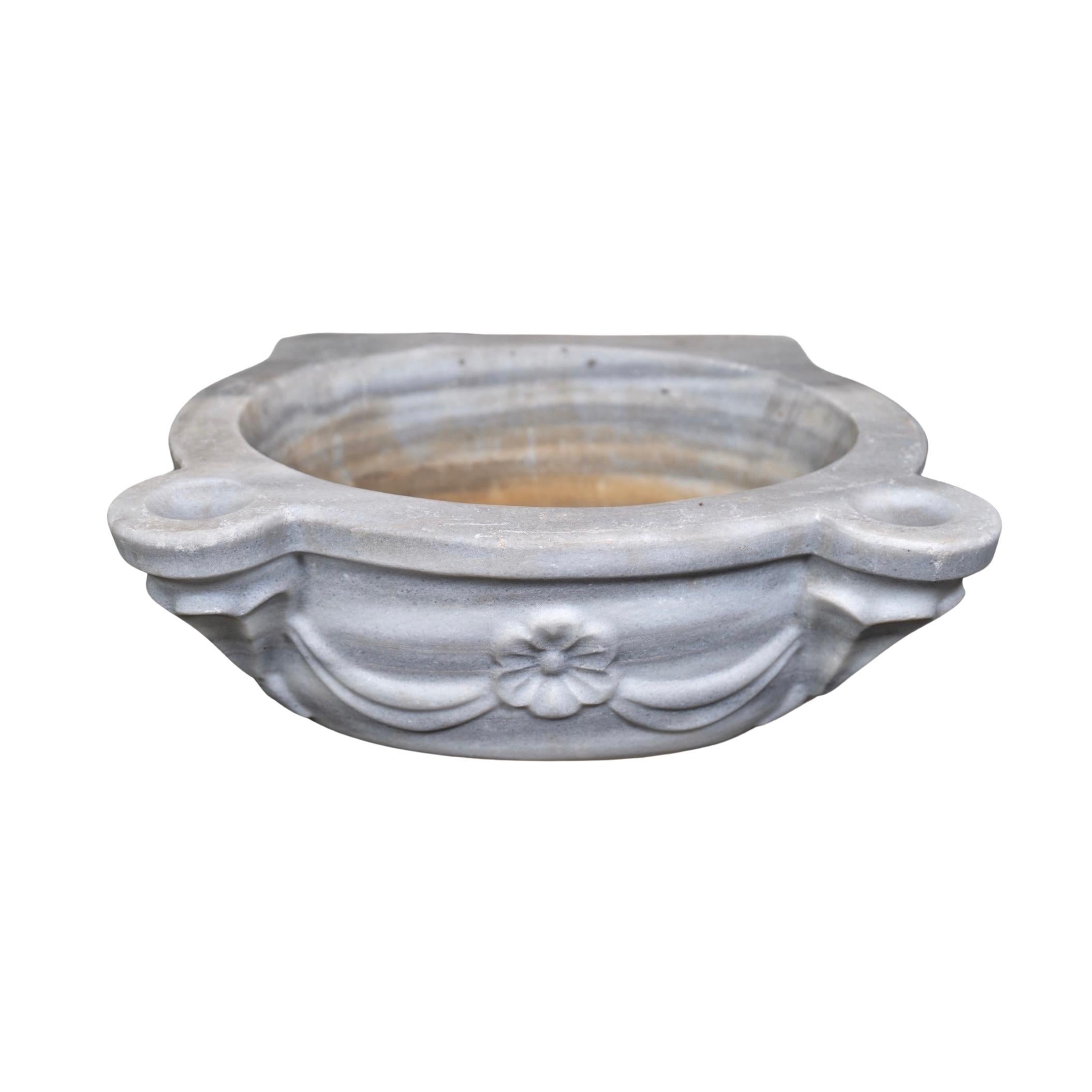 This premium French white marble sink is crafted from 18th century techniques, offering a timeless and refined aesthetic to any setting. Its unique composition remains durable and refracts light in beautiful ways. Its luxurious look and solid