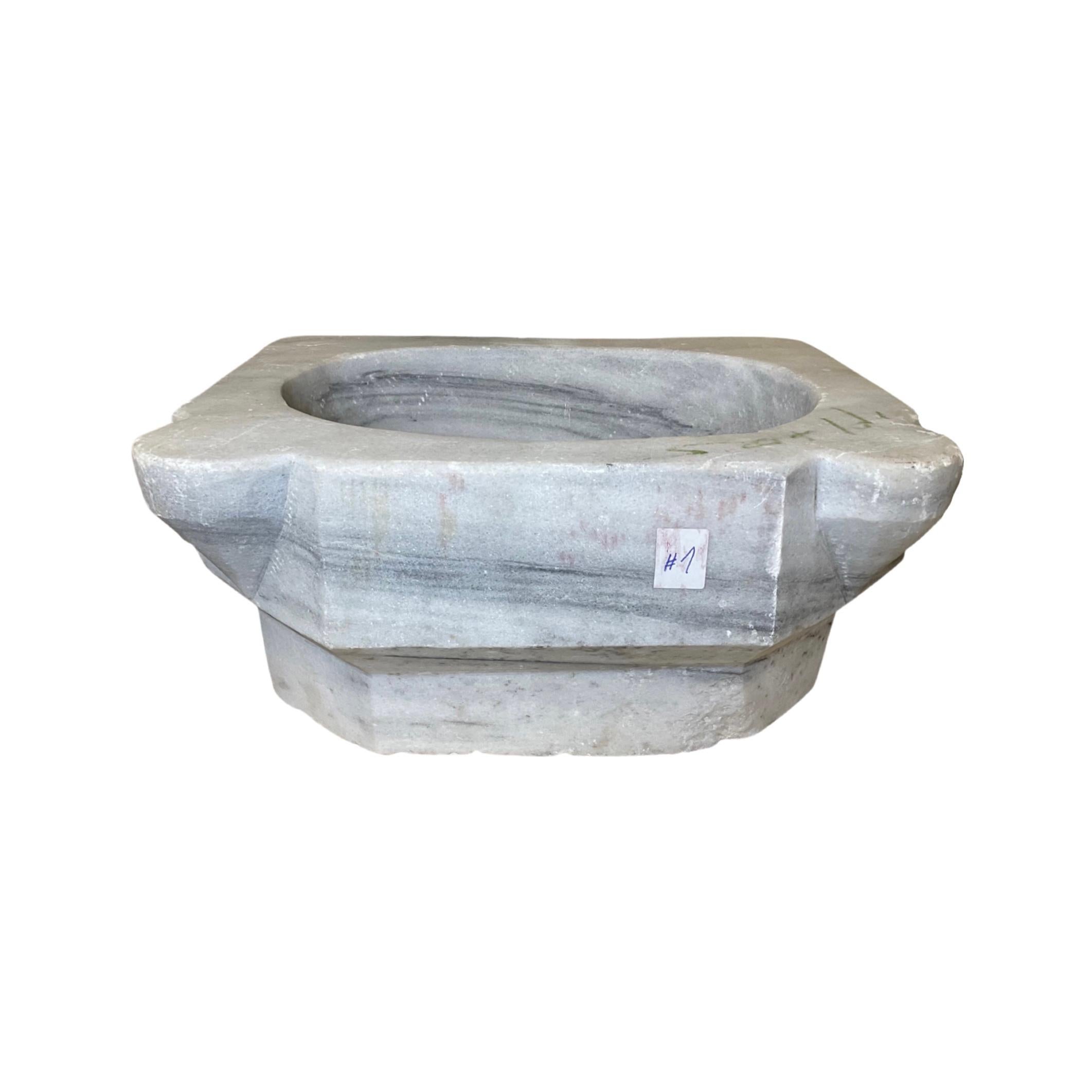 This classic French white marble sink is a unique piece of craftsmanship dating back to the 1850s. With a luxurious and timeless design, this sink will be a stunning feature in any bathroom. It is made of durable marble and features a glossy,