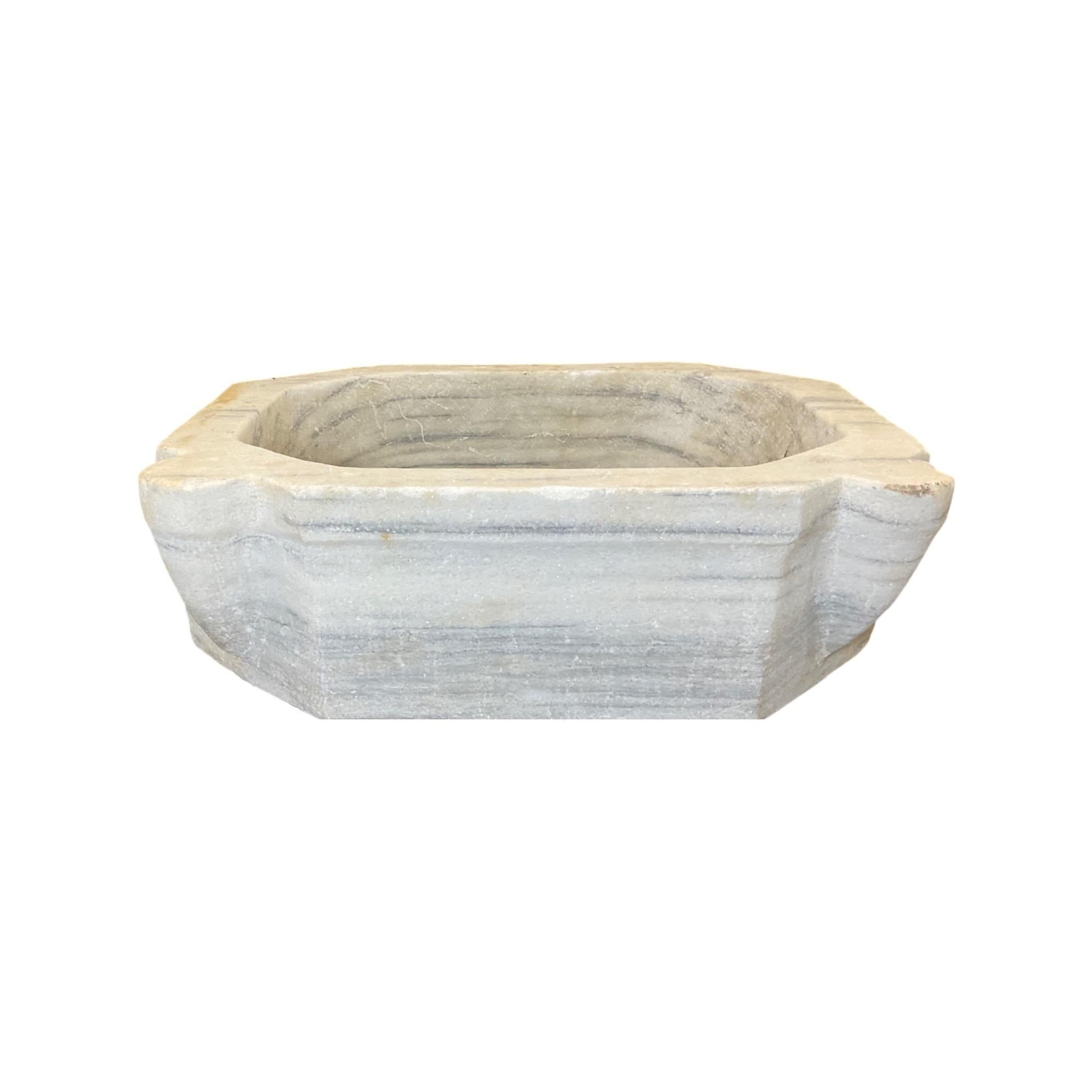 This French white marble sink is inspired by 18th century designs, offering timeless elegance and durability. Its luxurious marble construction features a smooth and glossy surface, giving any bathroom an air of sophistication and luxury. Its