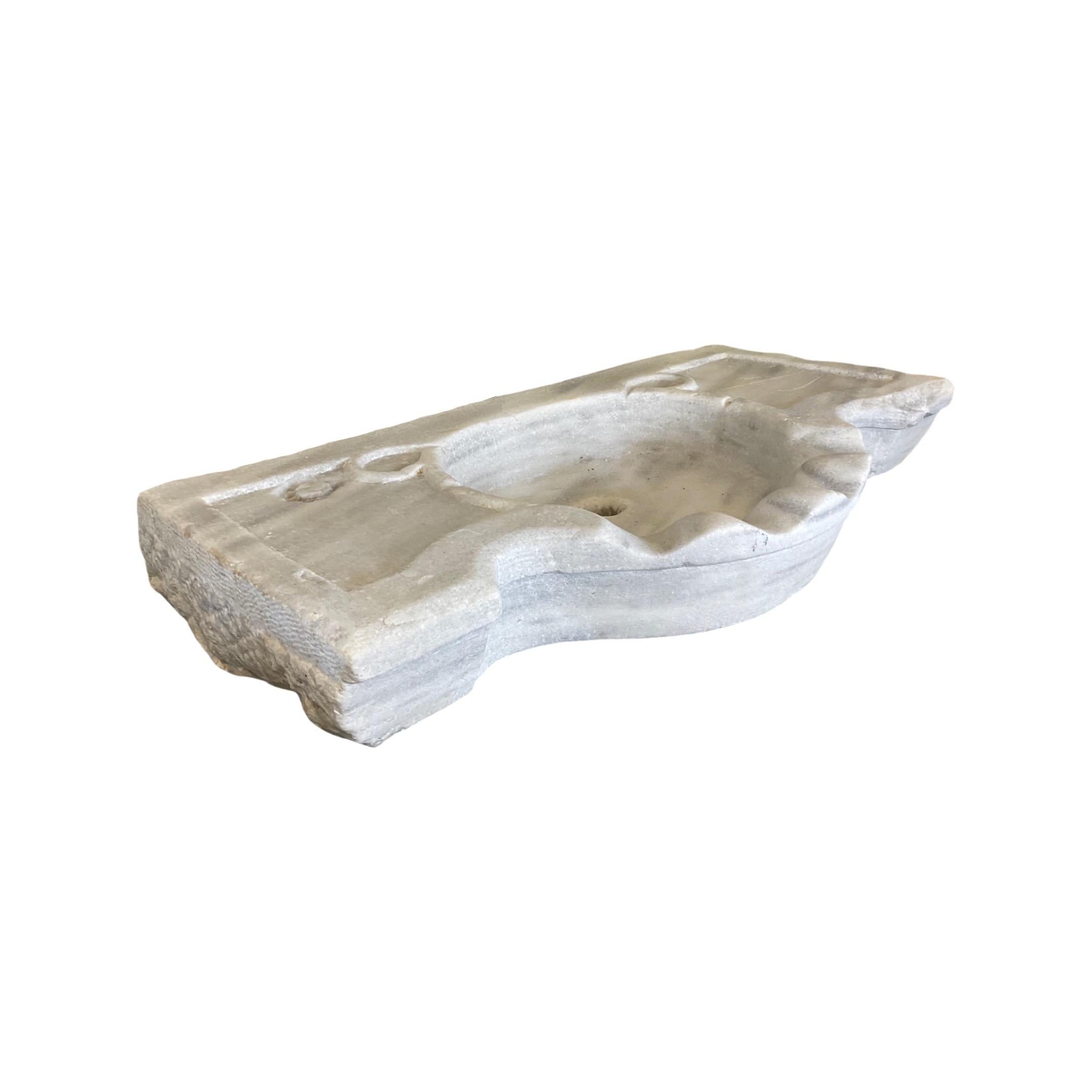 This French white marble Sink is crafted using 18th century techniques for a classic, elegant look. Its rectangular shape is sleek and modern, perfect for adding a touch of sophistication to any bathroom. The white marble is resistant to staining