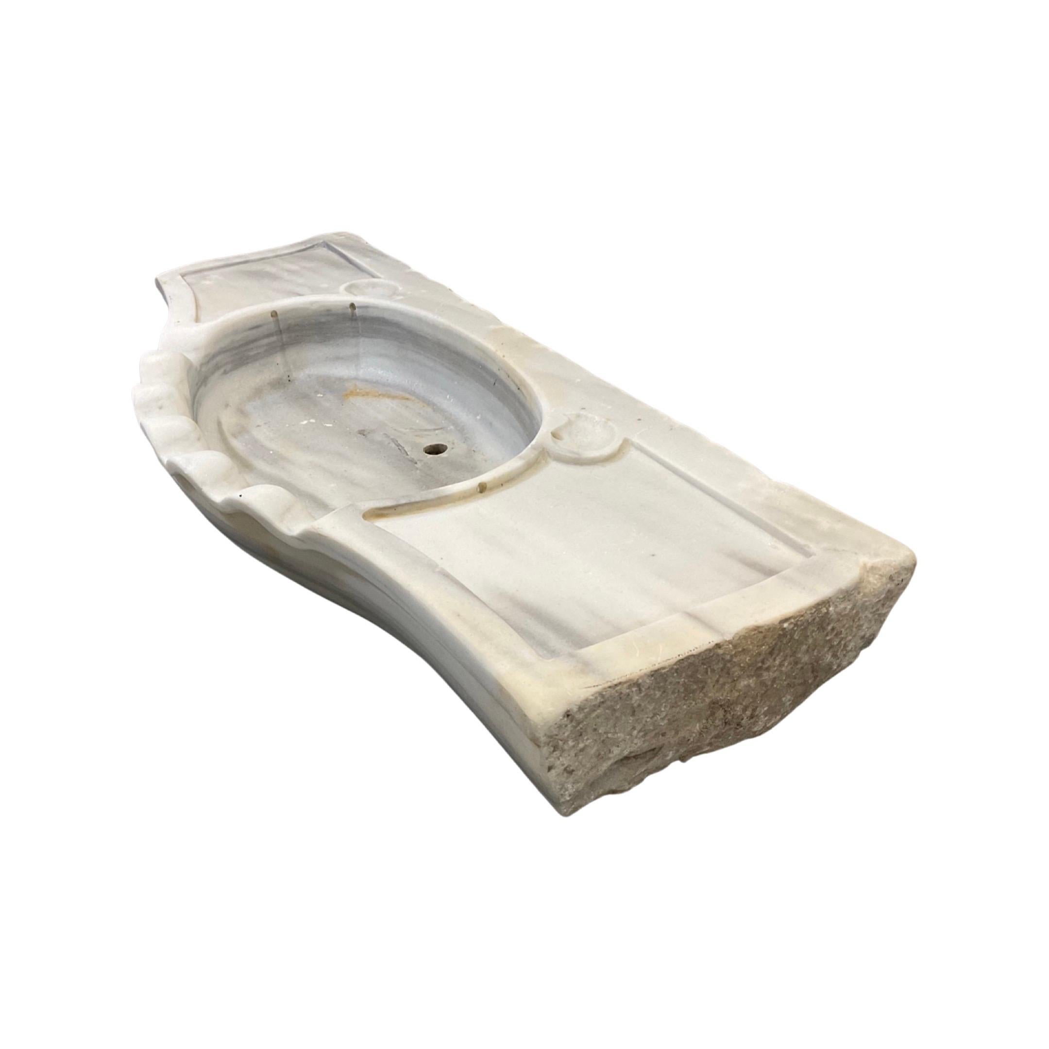This French White Marble Sink is a timeless design from the 18th century. Featuring a pristine white marble exterior and sleek design, it's an exquisite addition to any bathroom or kitchen. It's an ideal choice for those looking for an elegant and
