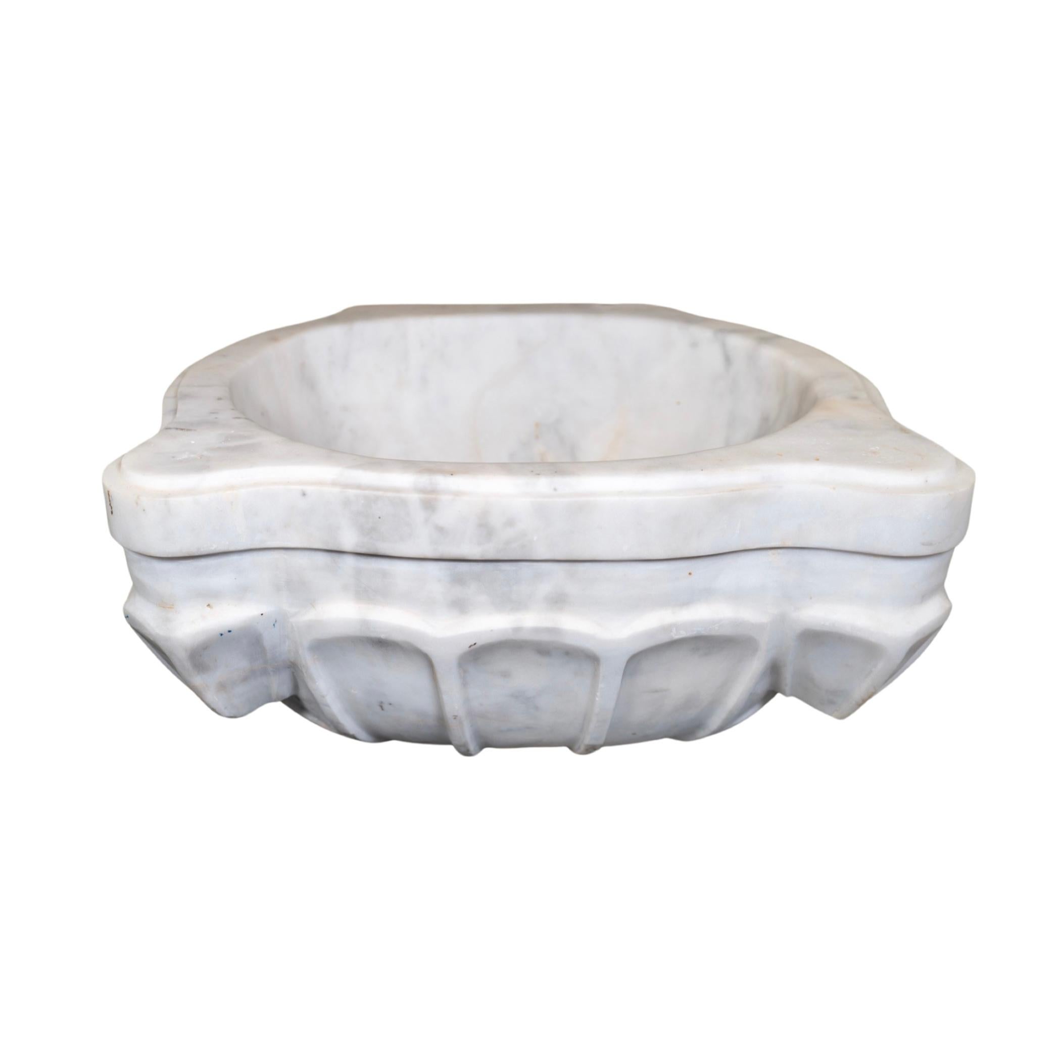 This premium French white marble sink is crafted from 18th century techniques, offering a timeless and refined aesthetic to any setting. Its unique composition remains durable and refracts light in beautiful ways. Its luxurious look and solid