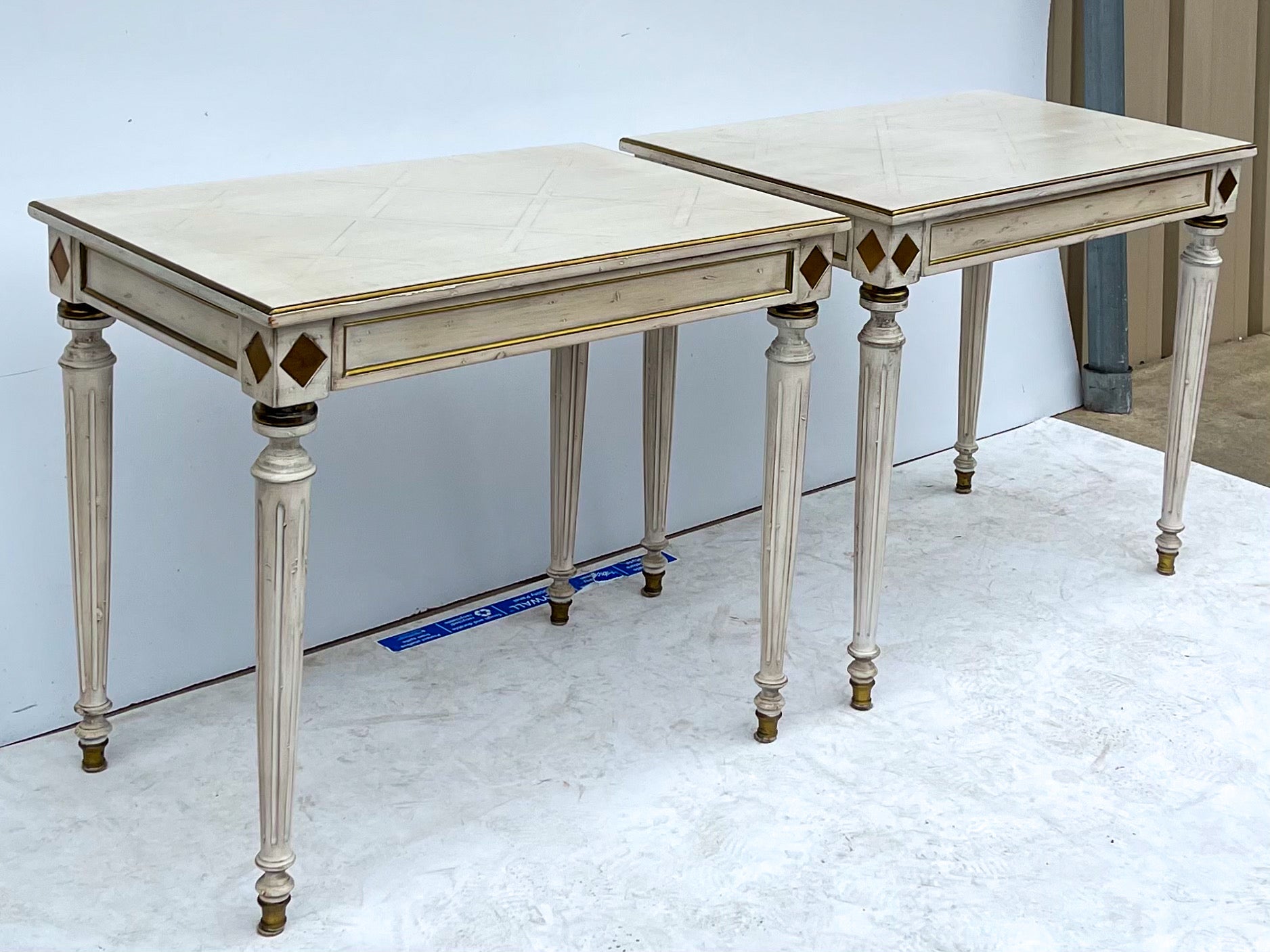 These are elegant! This is a pair of French white painted side tables with parquet marquetry tops. They have a single drawer and gilt accents. They are unmarked and possibly pine. Love the scale!