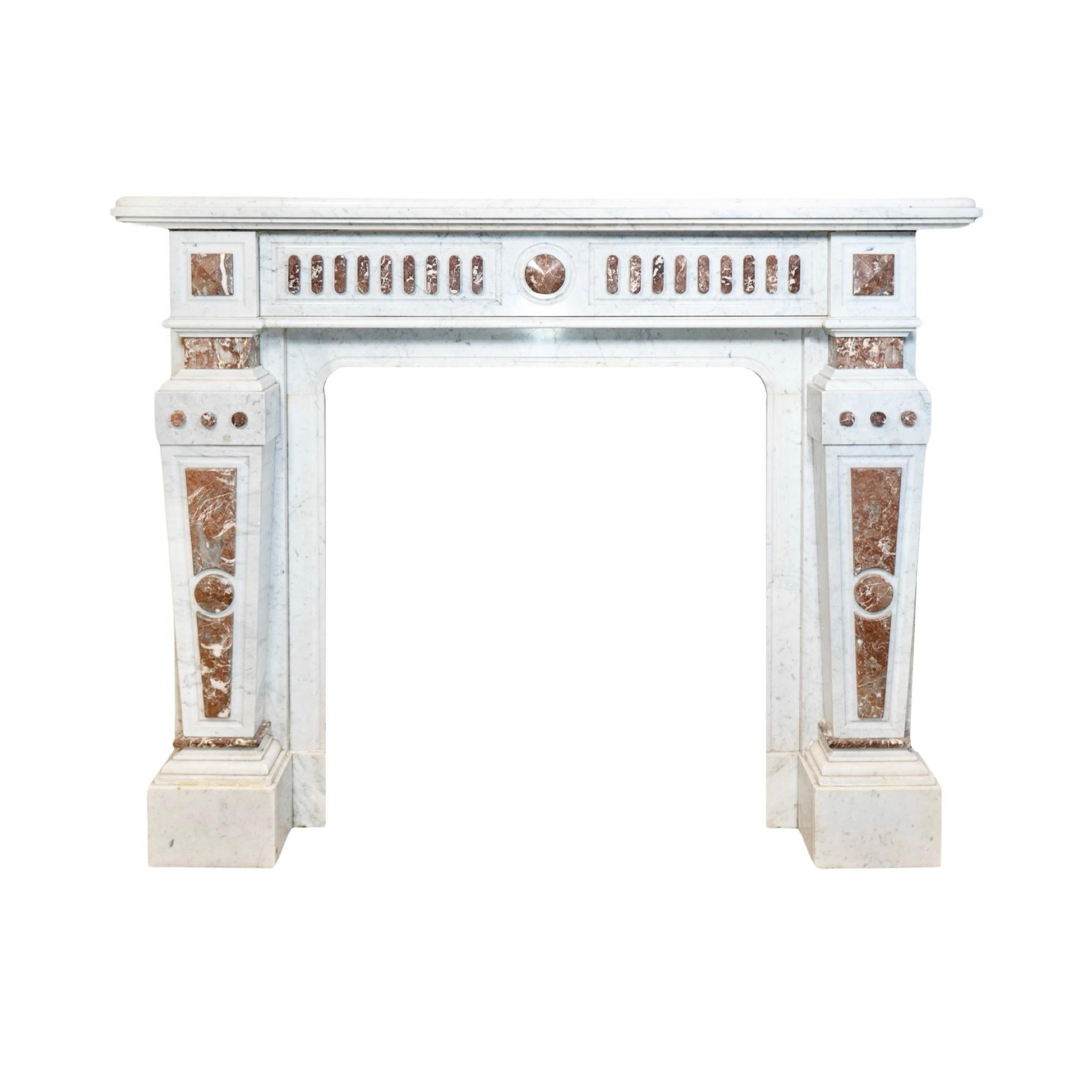 This 19th century French mantel is a classic and elegant addition to any home. The white veined Carrara marble adds timeless beauty, while the Royal Red marble accents provide a touch of luxury. Mined from France, this mantel is a true
