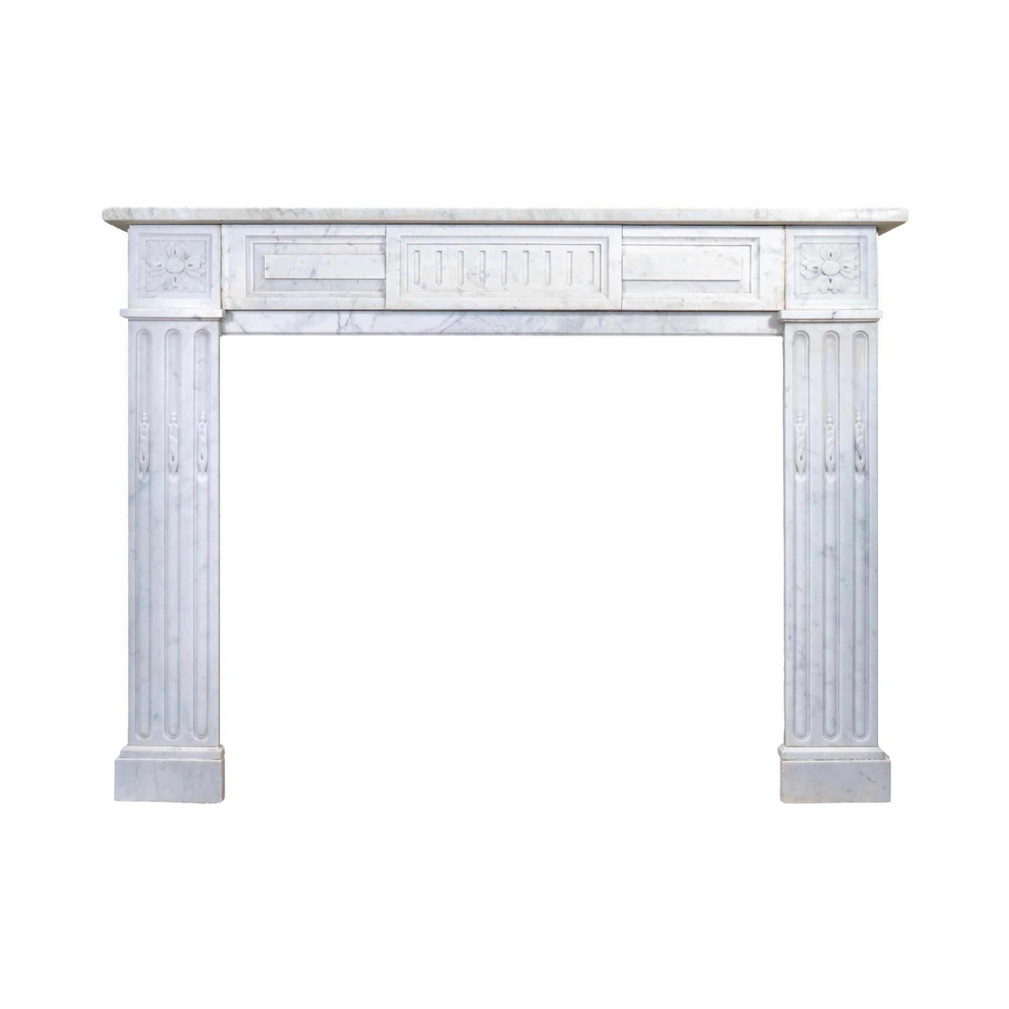 This 19th-century French White Carrara Marble Mantel exudes elegance and sophistication. Crafted from premium quality, white veined marble from France, it features exquisite styled carvings in the iconic Louis XVI style.
