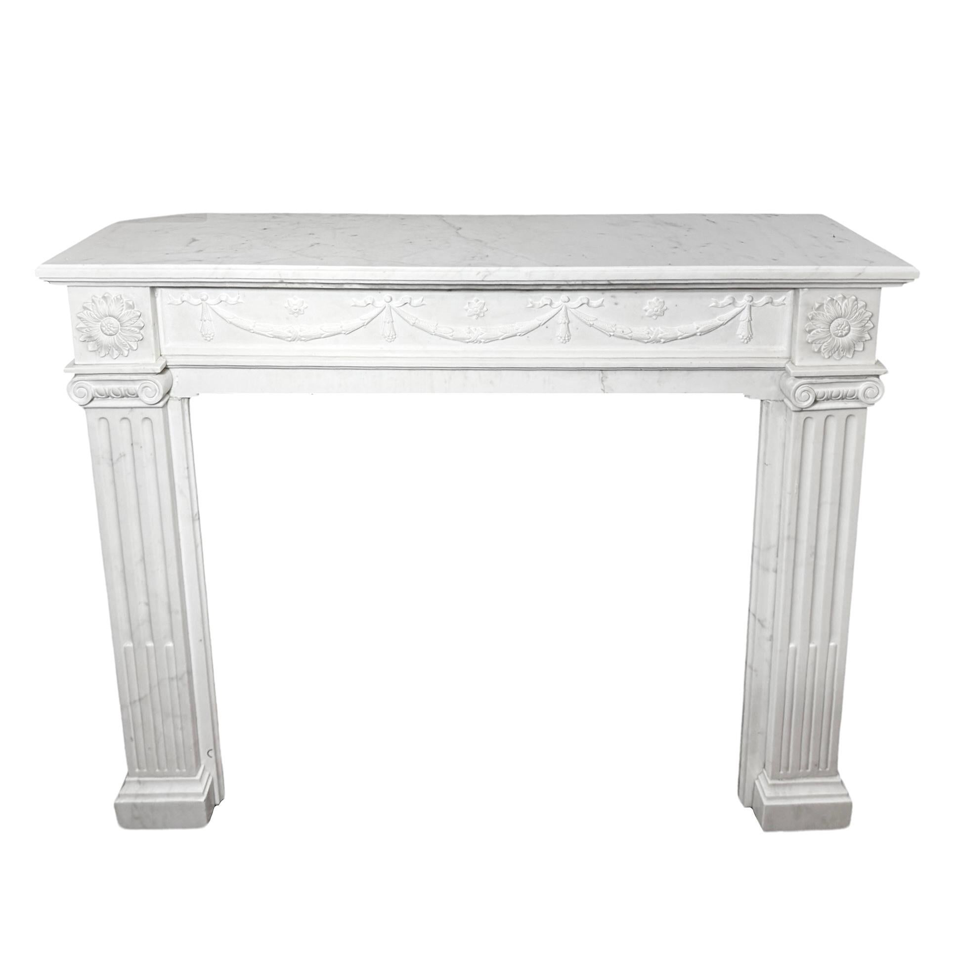 This French White Veined Carrara Marble Mantel is a beautiful and timeless addition to any home. Made of high-quality white veined Carrara marble from France and designed in the luxurious Louis XVI style, it features exquisite carvings that add an