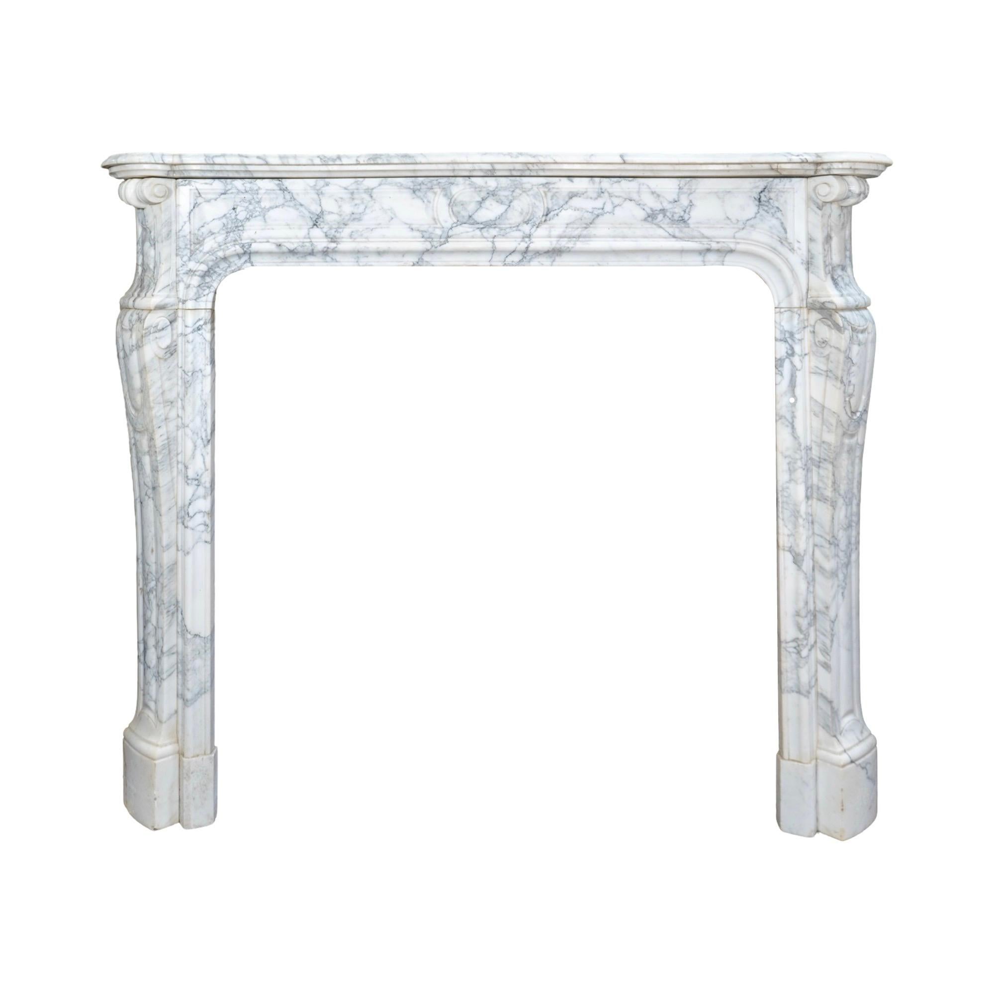 Crafted from exquisite French White Veined Carrara Marble, this 1890's Louis XVI style mantel boasts intricate carved details for a touch of elegance. Add a touch of luxury to your fireplace with this timeless piece, made from the finest marble from