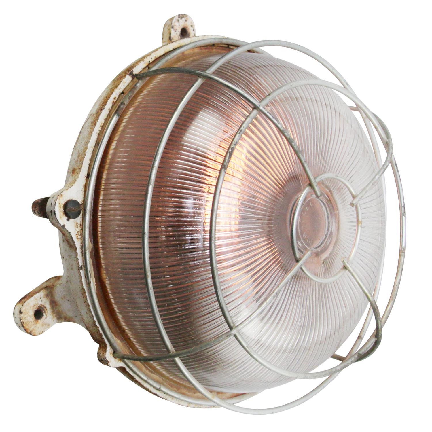 French Industrial wall / ceiling lamp by Mapelec, Amiens, France
Cast Iron back with clear striped glass.

Measure: weight 4.40 kg / 9.7 lb

Priced per individual item. All lamps have been made suitable by international standards for