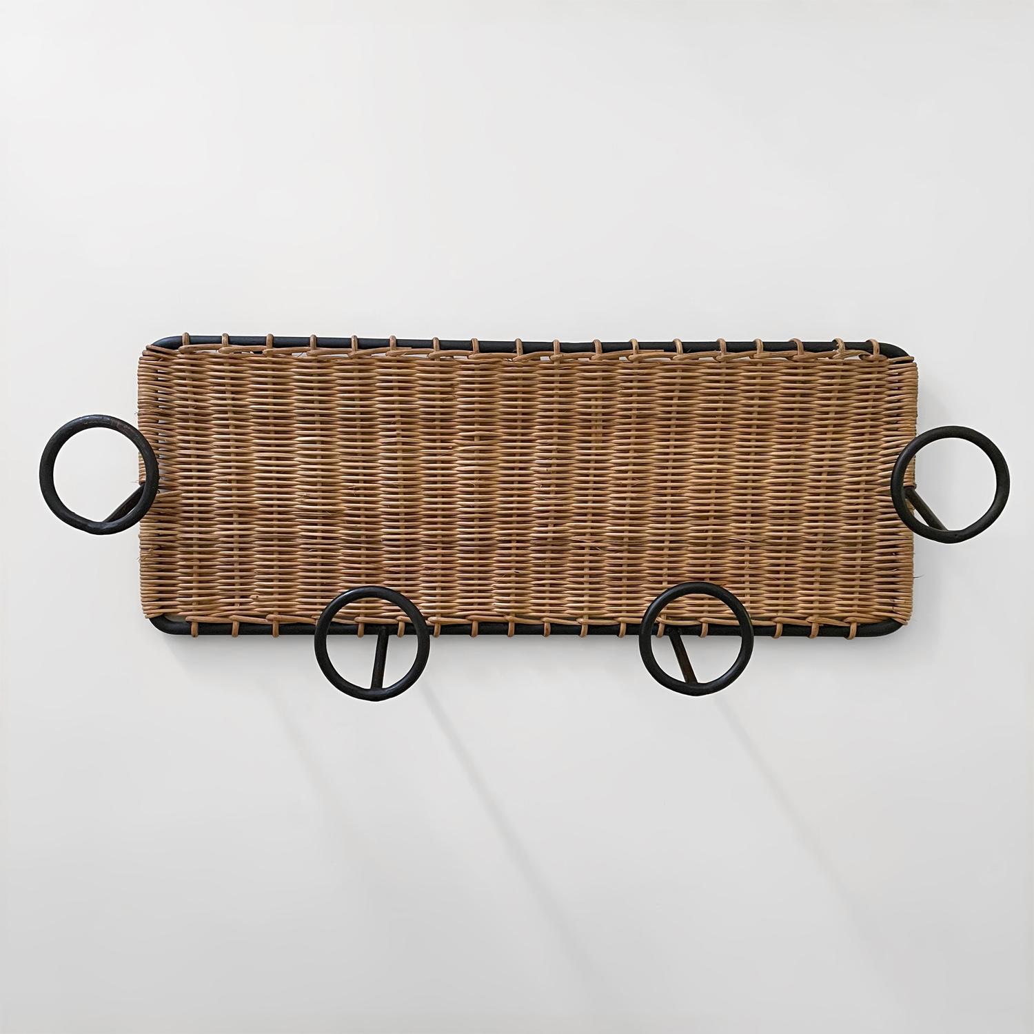 French Wicker and Iron Coat Rack in the style of Jacques Adnet 
France, circa 1950s
Wicker intricately woven around solid iron frame with four iron loop hooks 
Natural color variations
Beautiful form and function
Patina from age and use
We have a