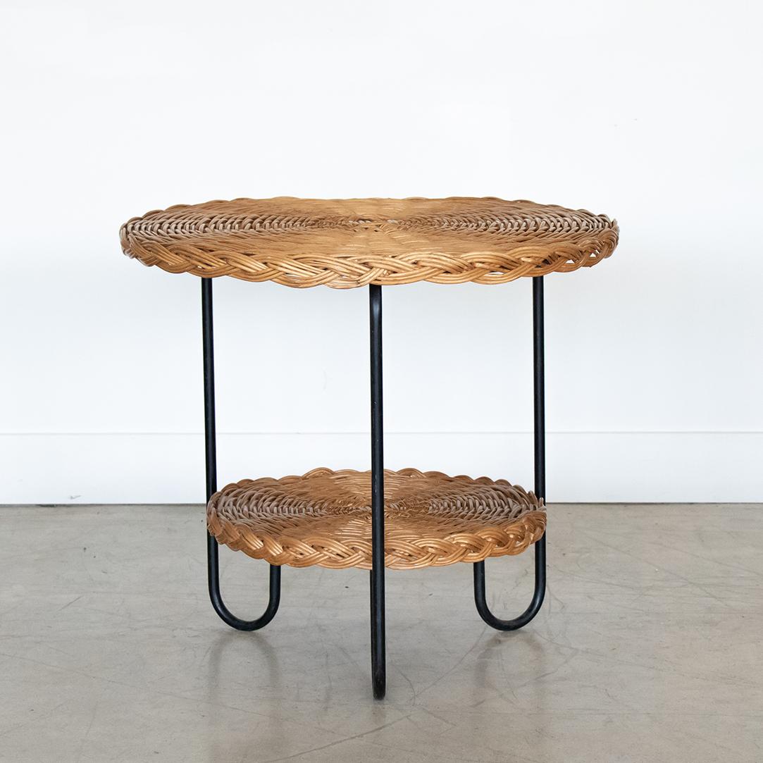 Large 1950's wicker and iron gueridon table from France. Original wicker table top with braided side detail around rim. Curved black iron legs with original chipped paint. Beautiful and functional design.
