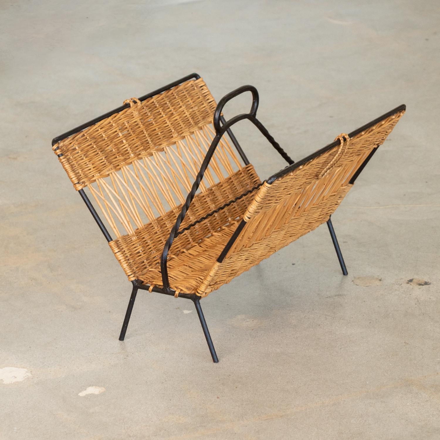 Beautiful wicker and iron magazine rack from France, 1950s. Twisted iron handle detail and original woven wicker sides. Nice age and patina throughout.