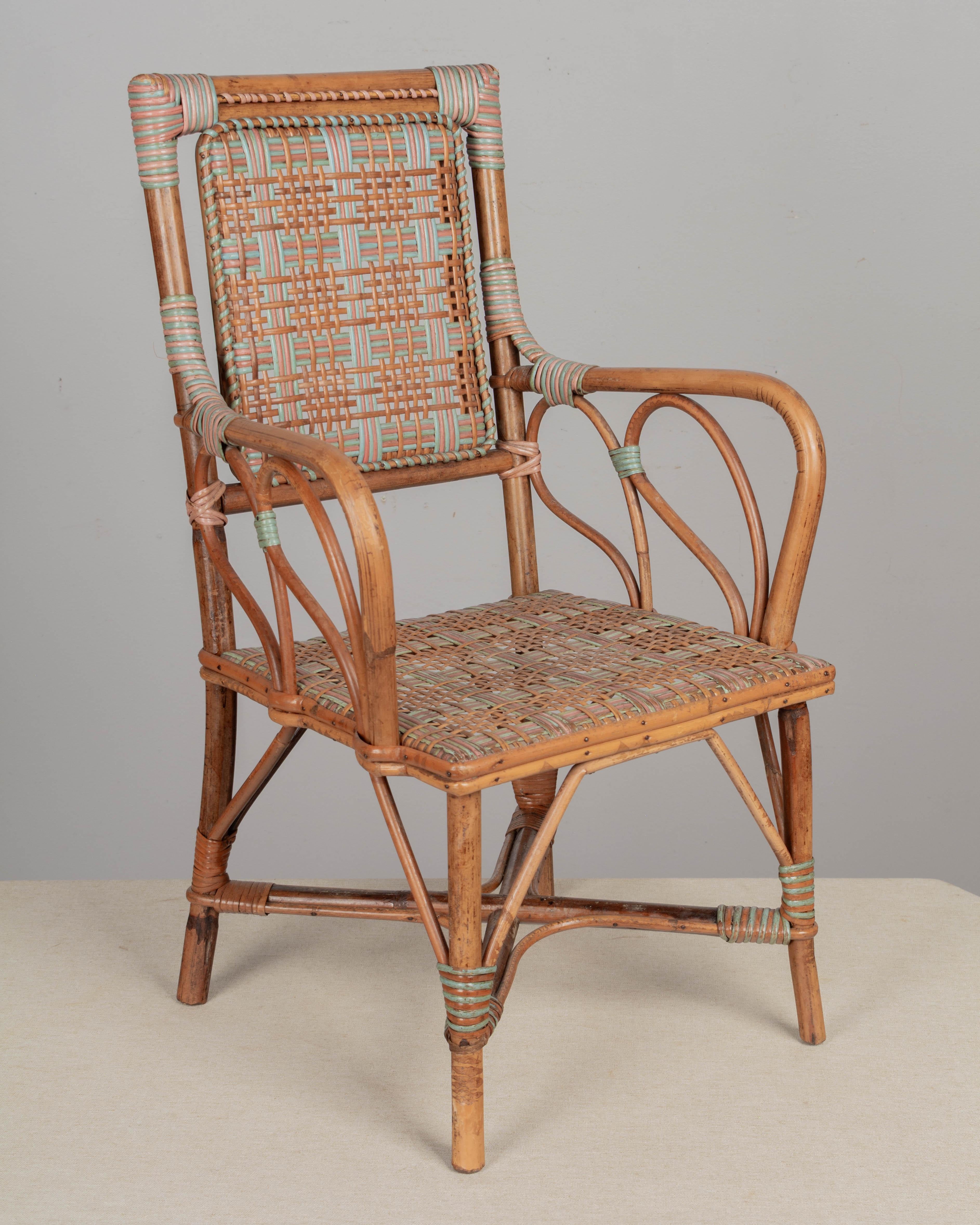 An early 20th century French child's chair with rattan frame and woven wicker seat and back. Good craftsmanship with pink and blue rattan woven in a plaid pattern. Circa 1900-1920
Dimensions: 15