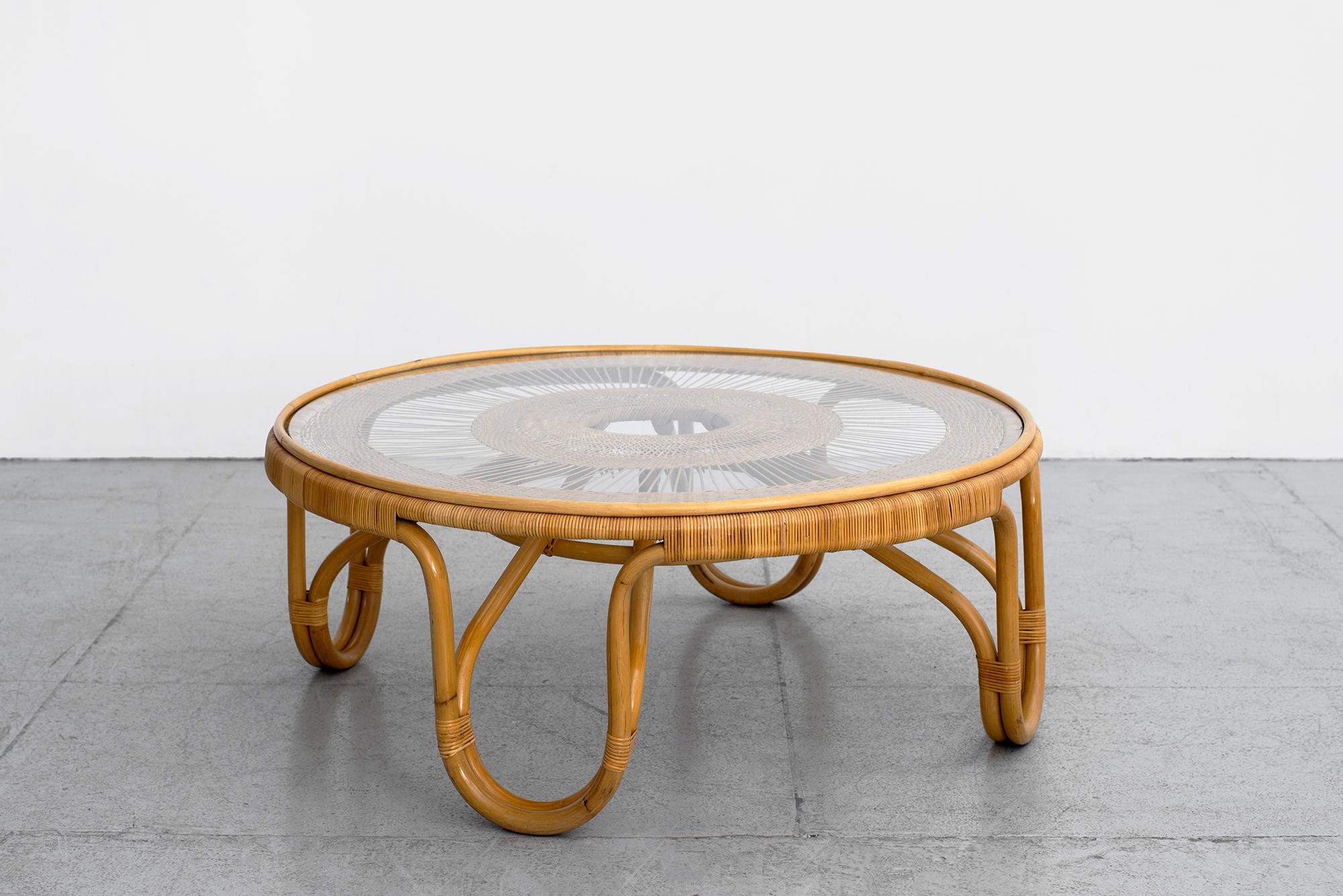 Wonderful French coffee table circa 1950s in wicker and rattan.
Hairpin shaped legs with detailed wicker weaving and glass top.
Wonderful piece.
   