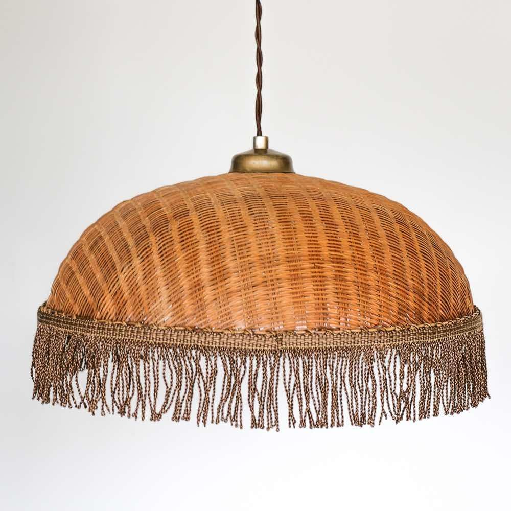 Great vintage wicker dome light from France, 1960's. Beautiful woven dome wicker shades with newly added brown silk tassel detail. Newly re-wired and new brass canopy. Measures 14.25