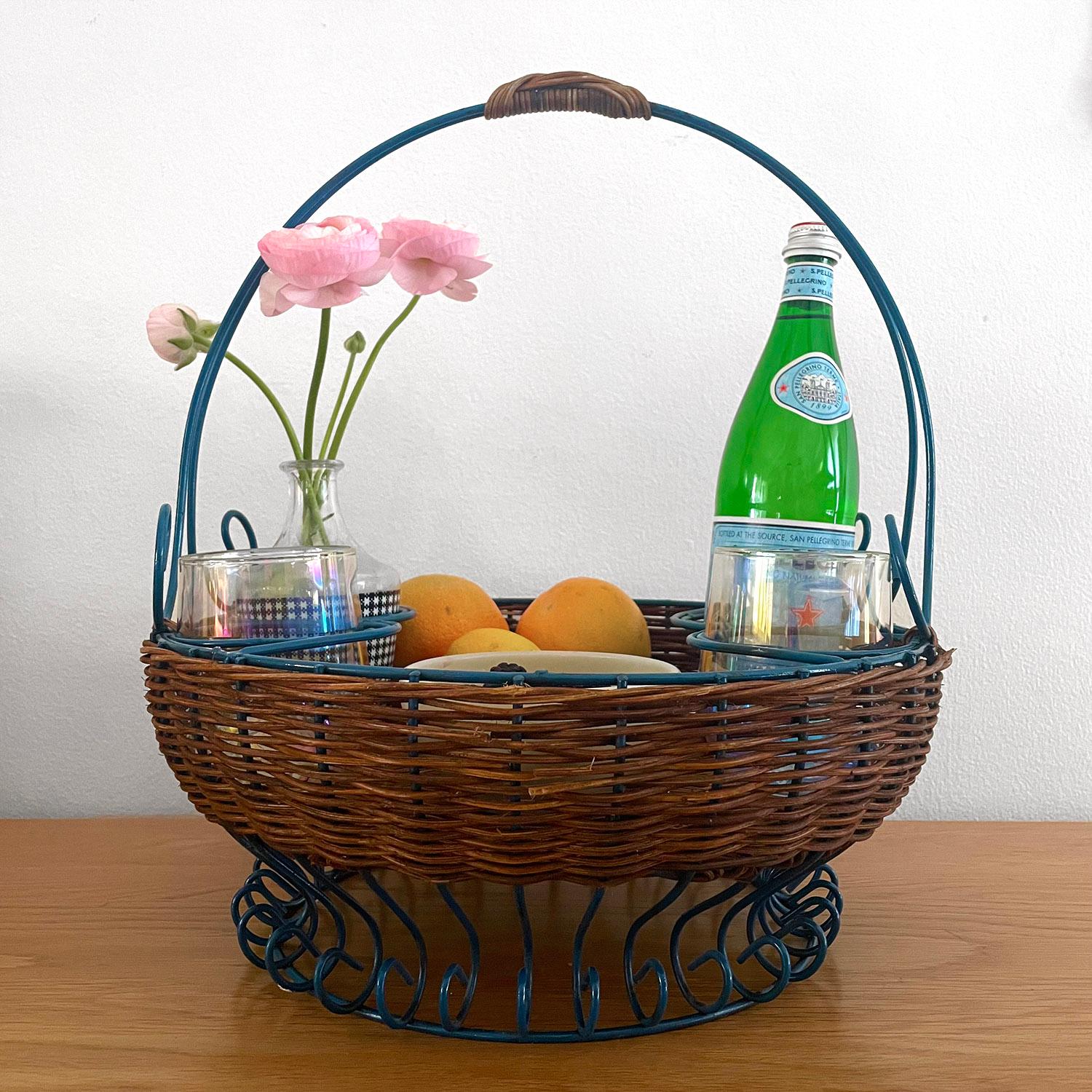 French wicker & iron service basket
France, 1950’s
This is a charming piece
Intricately woven wicker around deep blue painted iron frame
Beautifully sculpted frame and raised platform base with whimsical accents throughout
Four areas for bottles or