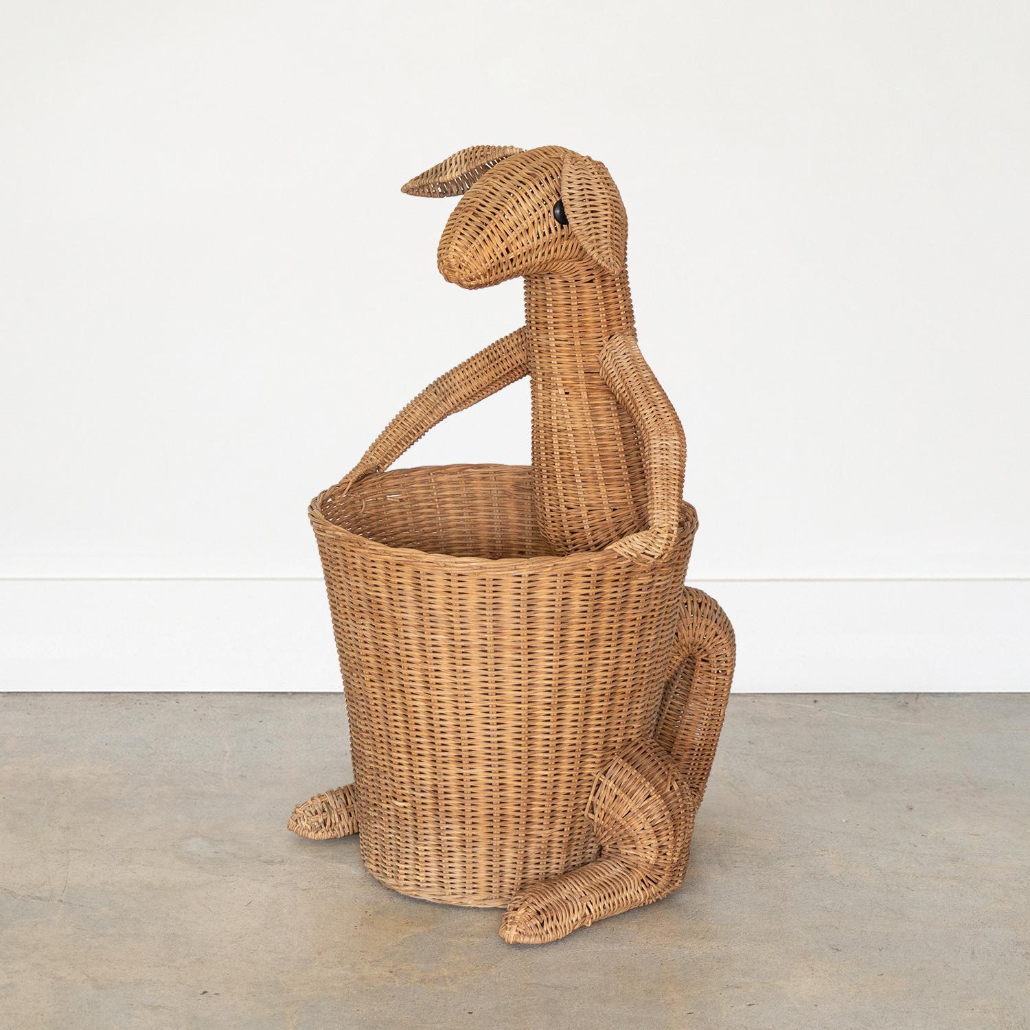Playful vintage French wicker decorative basket in the shape of a kangaroo and in the style of Mario Torres. Cute woven wicker curled tail, floppy ears and black button eyes. Large open basket perfect to hold toys, magazines, or a plant.