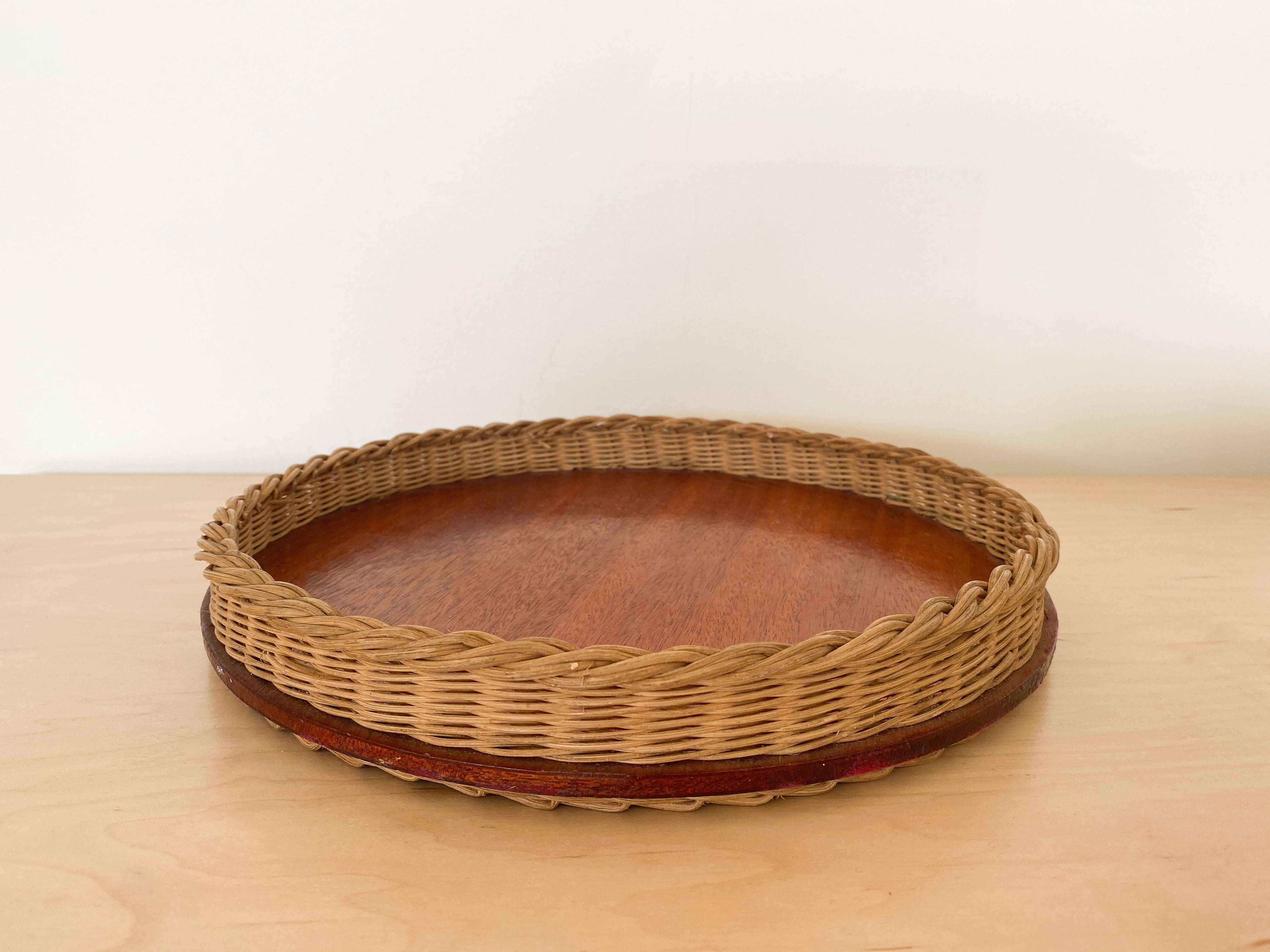 Circular woven wicker tray with leather wrapped detailing and wood bottom. Original piece from France with nice patina and age.