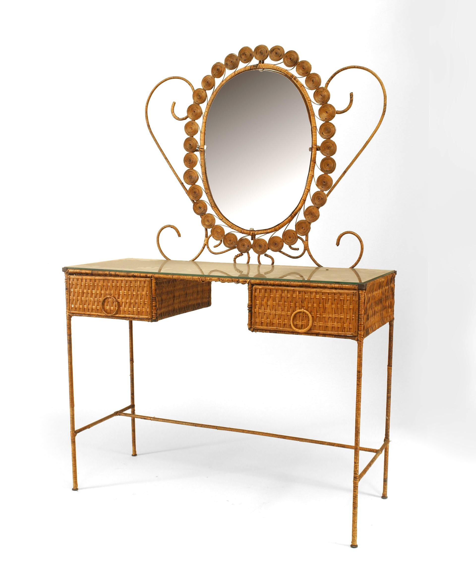 French natural wicker dressing table featuring a dramatically framed oval mirror, two drawers with circular pulls, and a glass top.