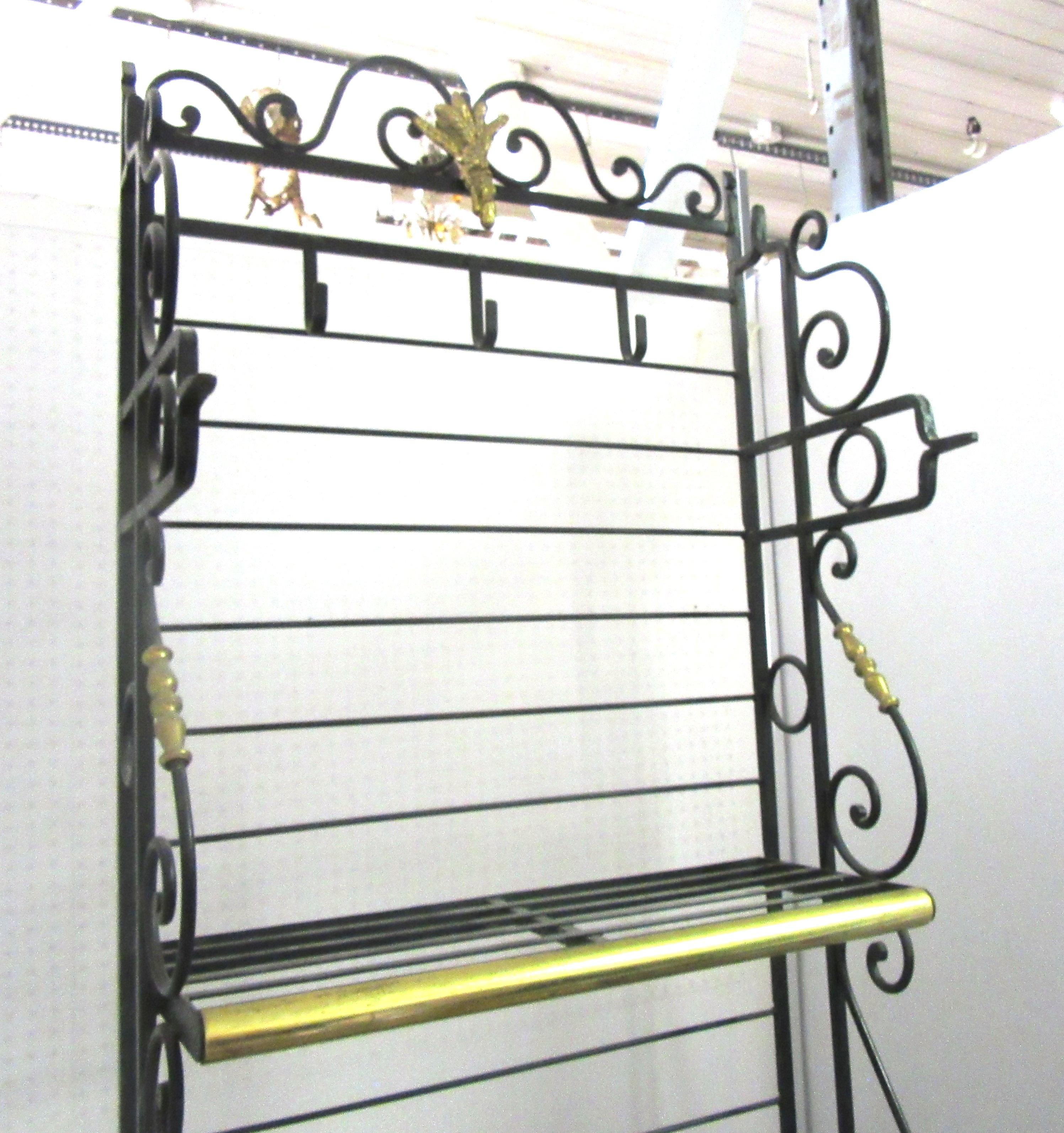 French turn of the century wine and cheese baker’s rack or bar unit. The piece has hooks on the top to hang cheese or meats, a wood butcher block in the middle to cut items, and a secure caged bottom where wine or liquor can be stored. The bottom