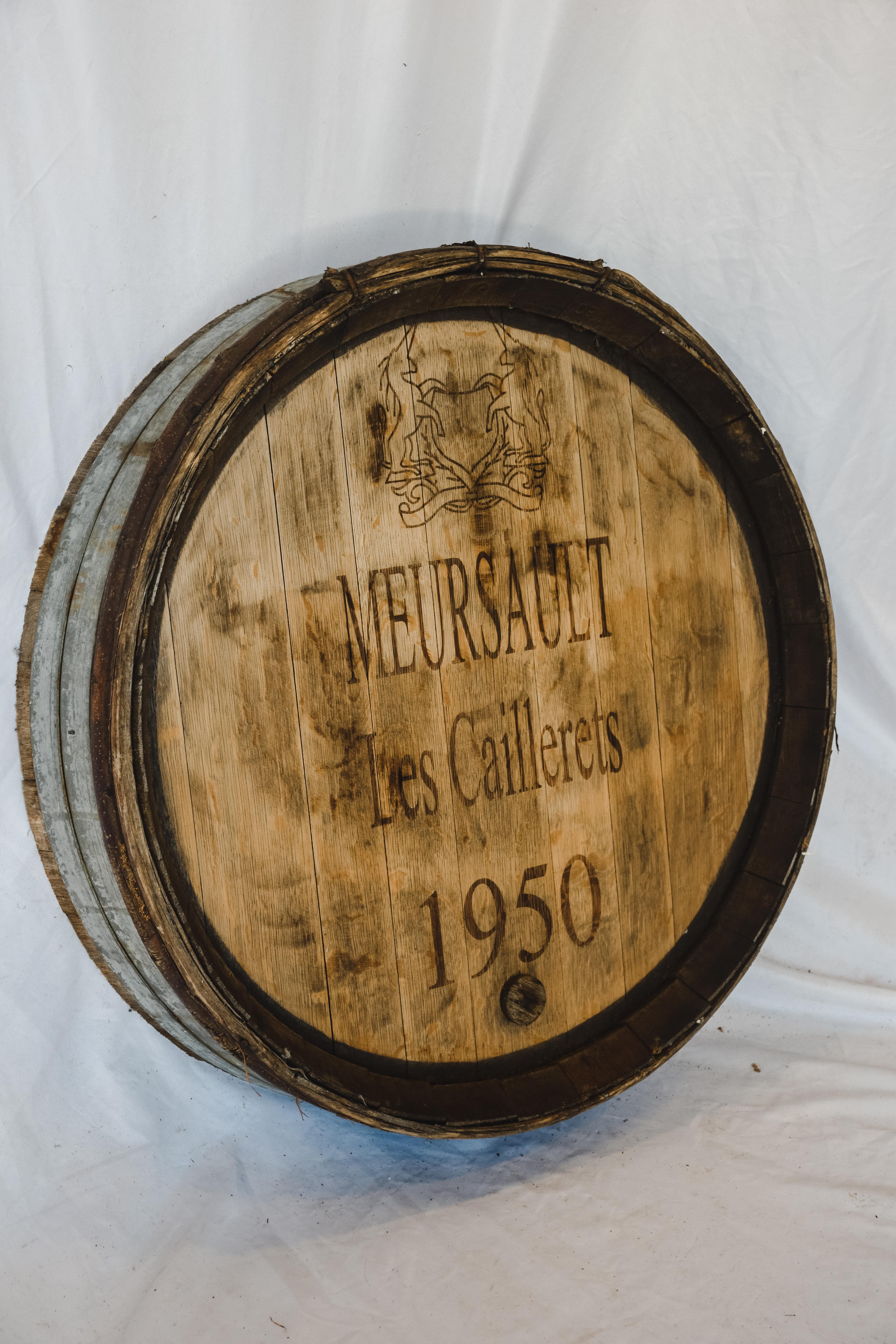 This Antique Wine Barrel Façade comes out of the wine cellars in France. The character and aged wood give it perfect presentation to hang in your wine room or any living space. The Meursault Les Caillerets 1950 custom stamp was added at a later