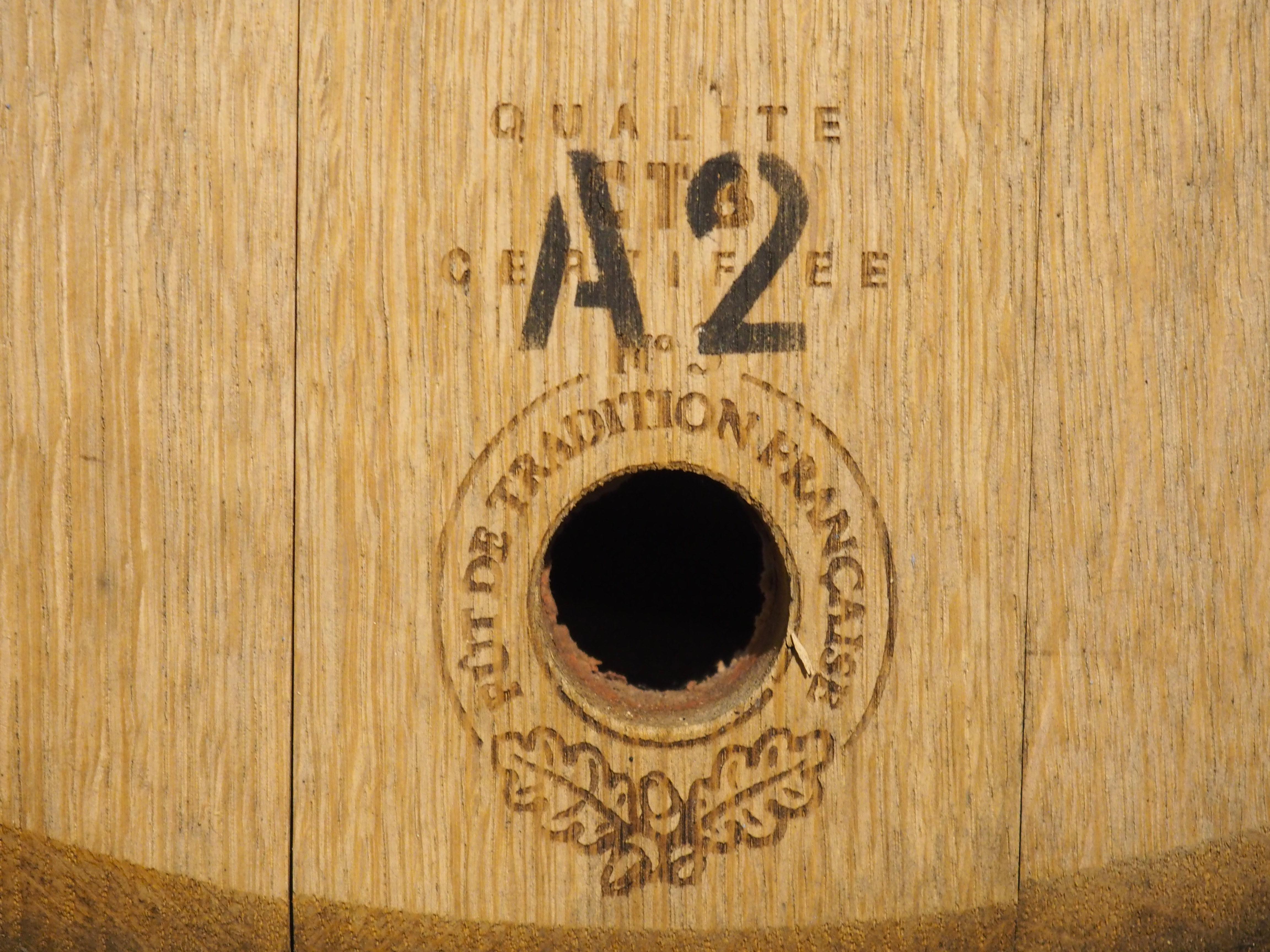 Originally part of a French oak wine barrel, dating to at least the 1950s (possibly older), this wine barrel head has been repurposed into a facade that is the perfect accessory for a bar area or wine room. The facade has been painted more recently