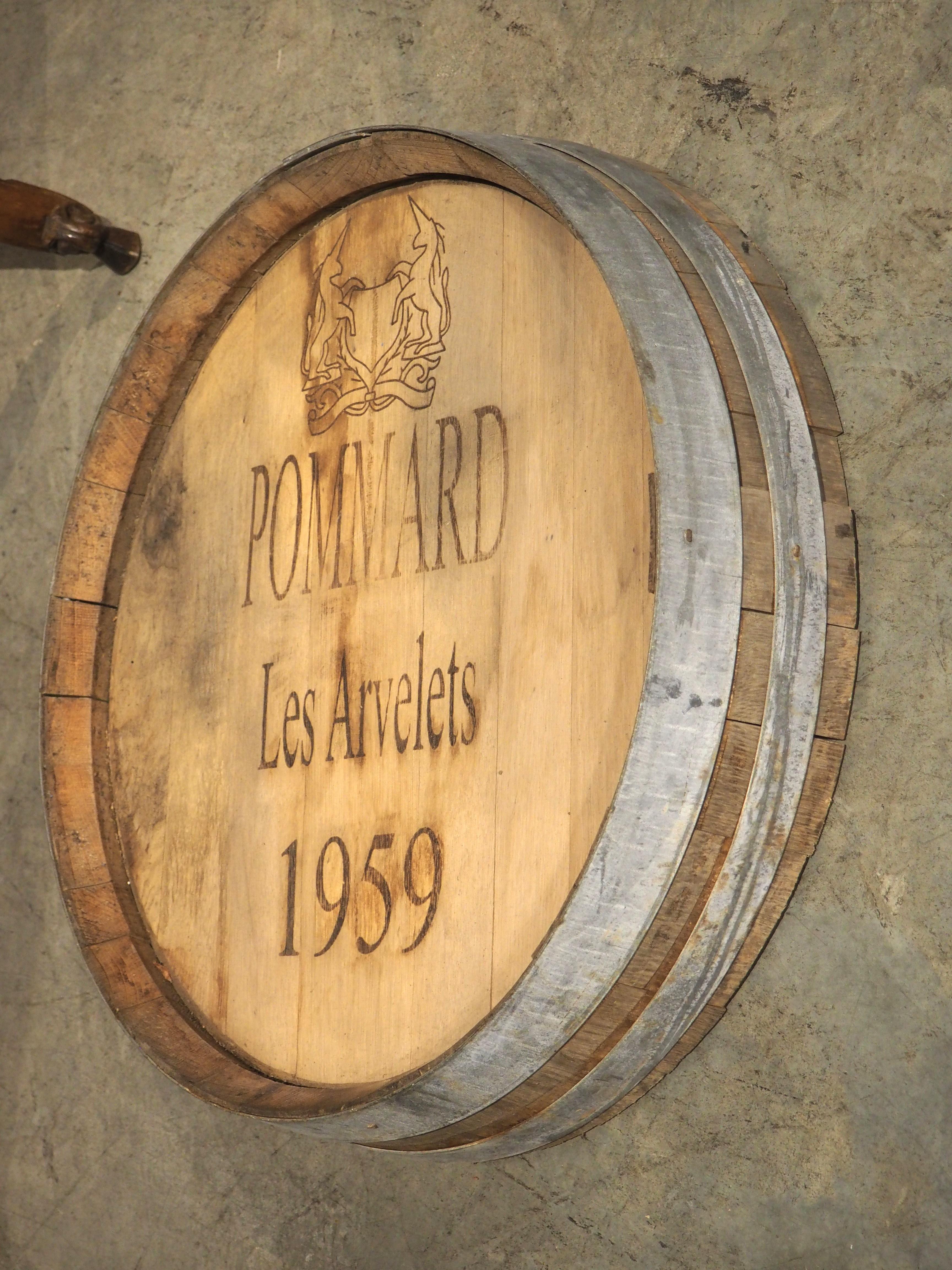 Originally the head of a French oak wine barrel, dated 1959, this wine barrel frontage is a perfect wall-mounted accessory for a bar room or wine cellar. The beige facade has been painted brown with the appellation and stylized label of a wine