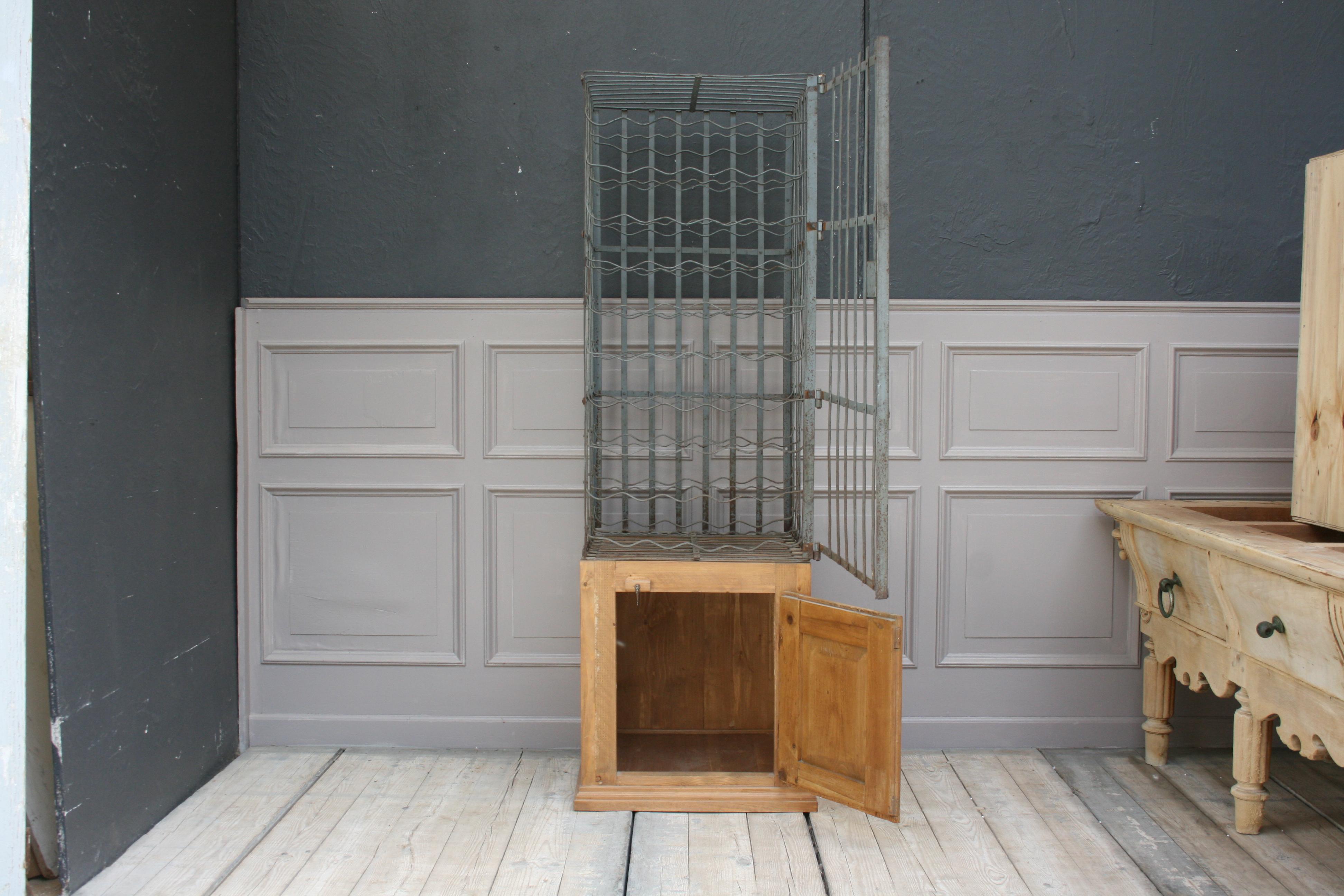 Early 20th century French wine cage with wooden cabinet. The cabinet was newly built with the original old door.
Dimensions:
61/ 175 cm high / 24/ 68.89 inch high,
58 cm wide / 22.83 inch wide,
56 cm deep / 22.04 inch deep.