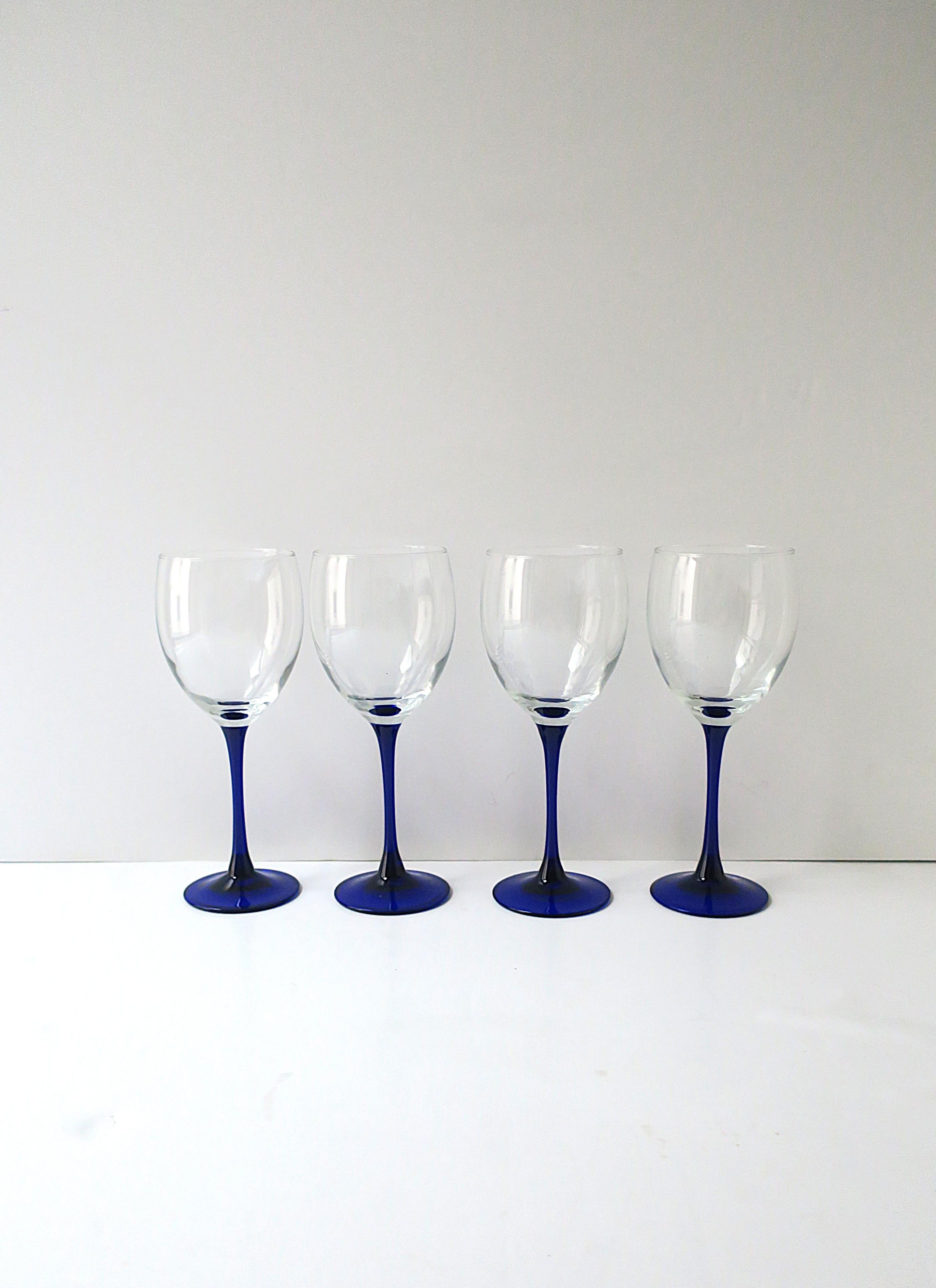 A set of four (4) French wine glasses with sapphire blue stem, circa late-20th century, France. Marked 'France' on underside as shown in last image. 