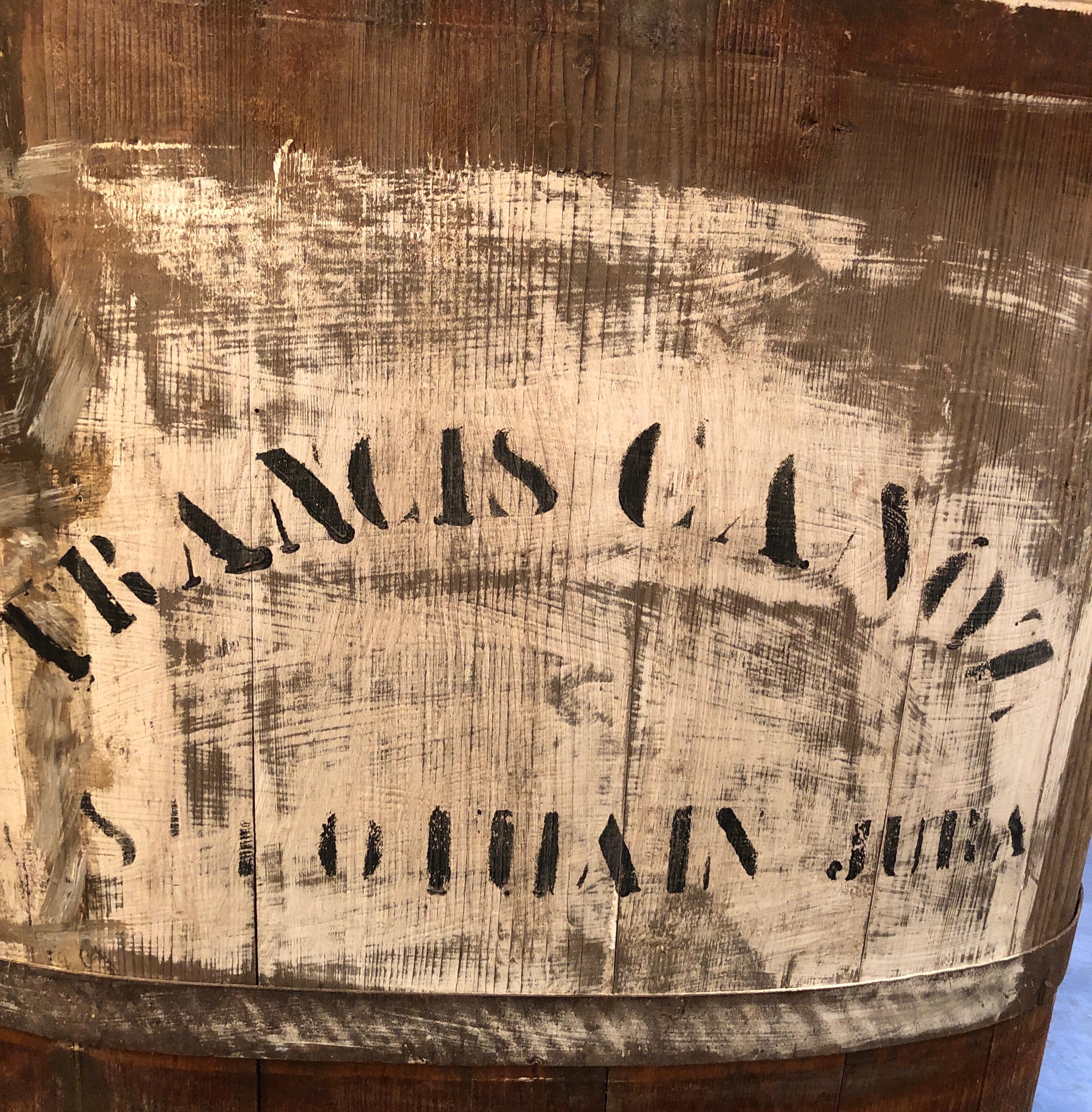A large stenciled and coopered wine vineyard bin used by a grower in the late 19th Century to collect wine grapes in the Burgundy region of France. The striking shape and patina features old white and black painted stencils on two sides of the bin