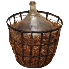 FRENCH WINE JUG WITH IRON STORAGE CAGE