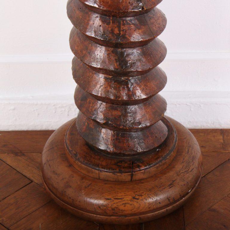A 19th century French hand-hewn screw from a wine press, now a pedestal with a large, heavily-turned base and a square top. As seen in the dining room of Coco Chanel's Villa La Pausa.
                          
 