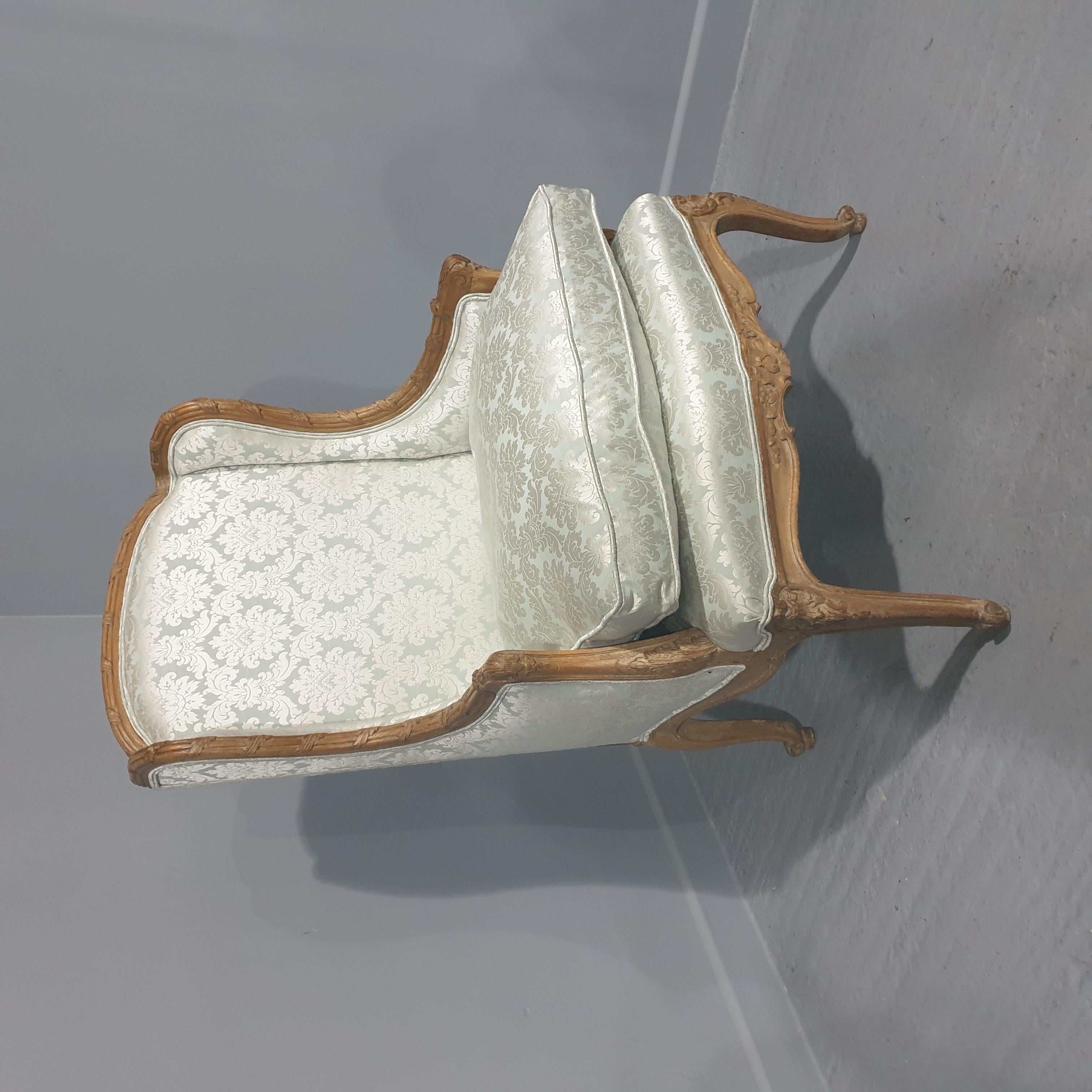 A lovely French bergere winged armchair, recently reupholstered in aqua marine damask, very comfortable, and in excellent original condition.