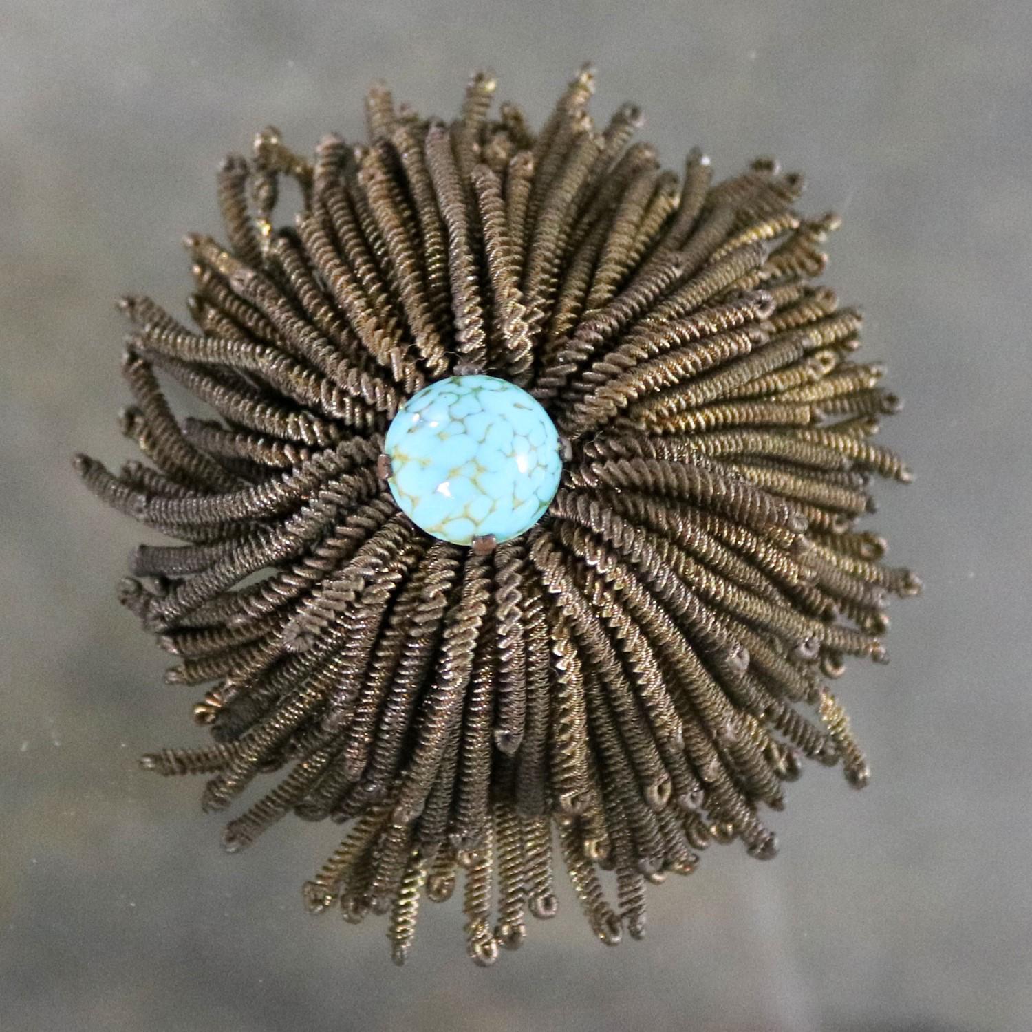 Fabulous vintage French brooch made of twisted gold tone wire fringe to resemble a spider chrysanthemum with a beautiful turquoise colored setting in the centre and marked Déposé as well as Made in France. It is in wonderful vintage condition. We