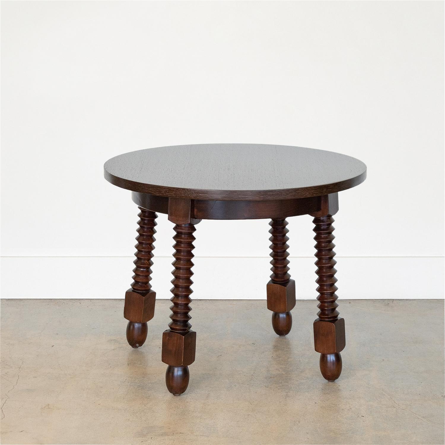 Beautiful four leg carved wood gueridon table in the style of Charles Dudouyt, made in France, 1940s. Circular top with carved wood legs and ball feet. Newly refinished wood in dark stain showing beautiful grain.